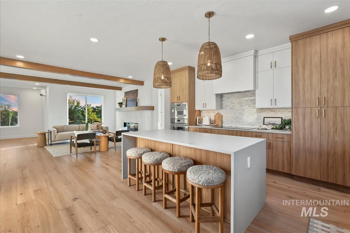 Expansive open-concept living area featuring wide-plank wood-finish flooring