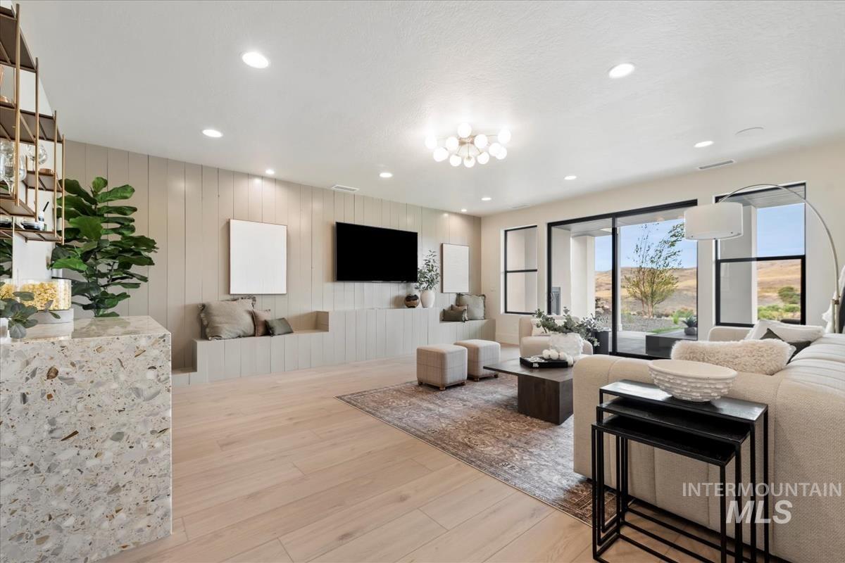 Living room featuring light wood-style flooring and recessed lighting