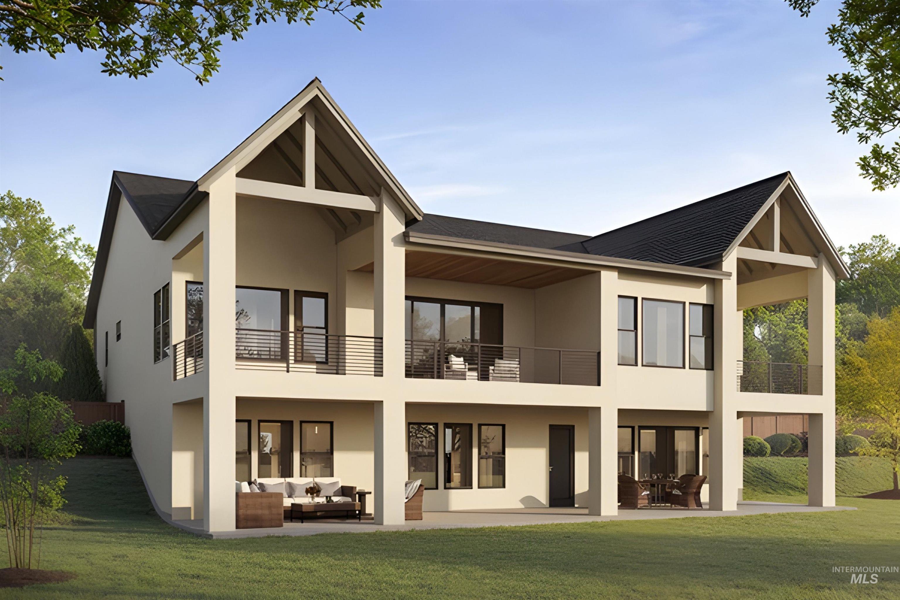Rear view of house with a lawn, stucco siding, and a patio area
