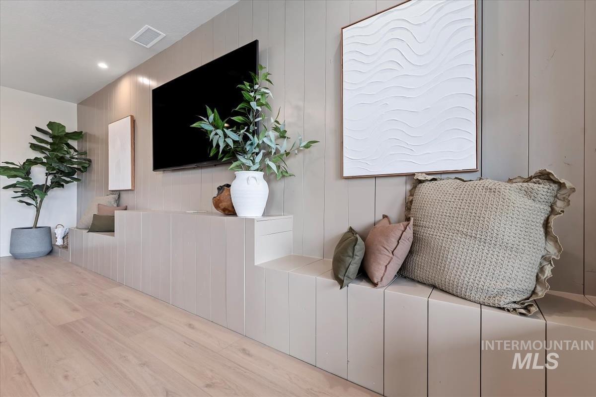 Living area featuring wood finished floors and wood walls
