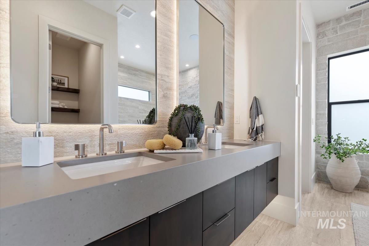 Bathroom with double vanity and recessed lighting