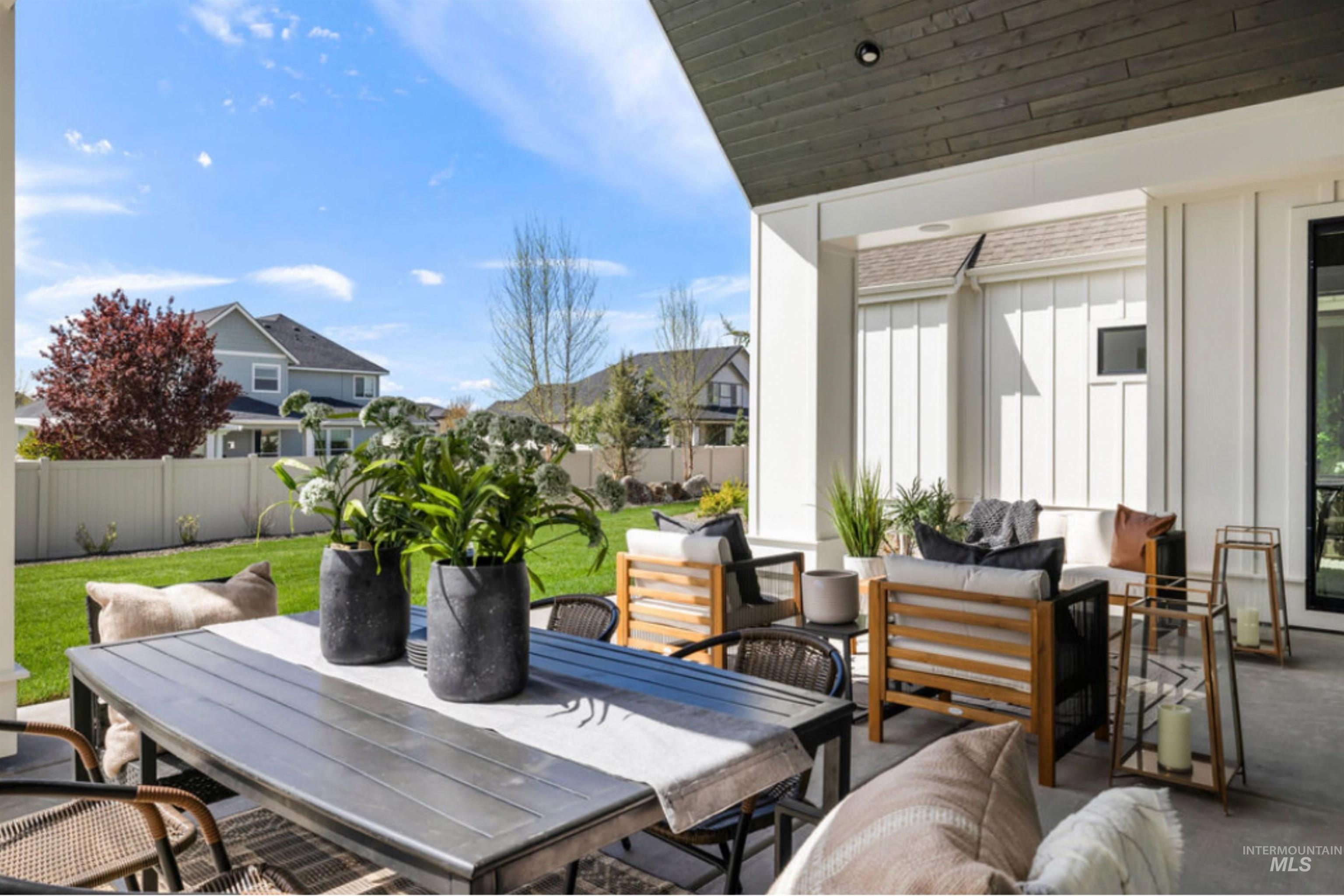 Fenced backyard with an outdoor hangout area, a patio area, outdoor dining space, and a residential view