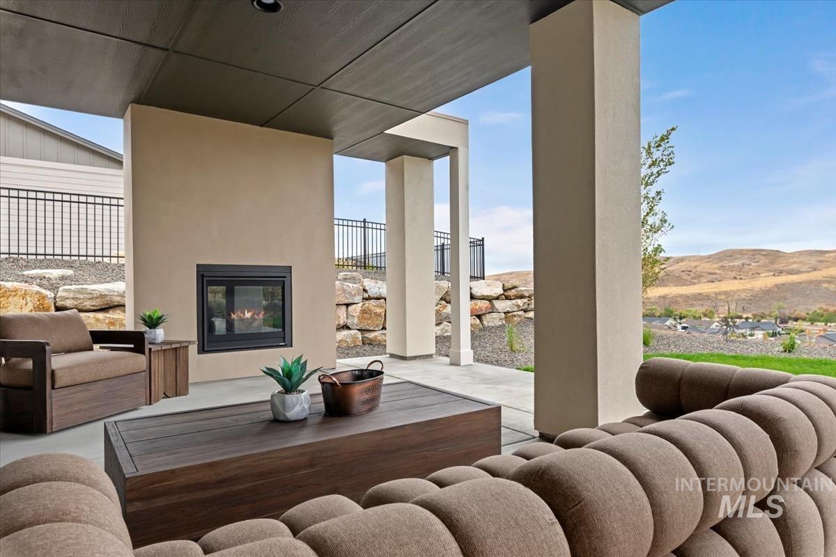 View of patio featuring an outdoor living space with a fireplace
