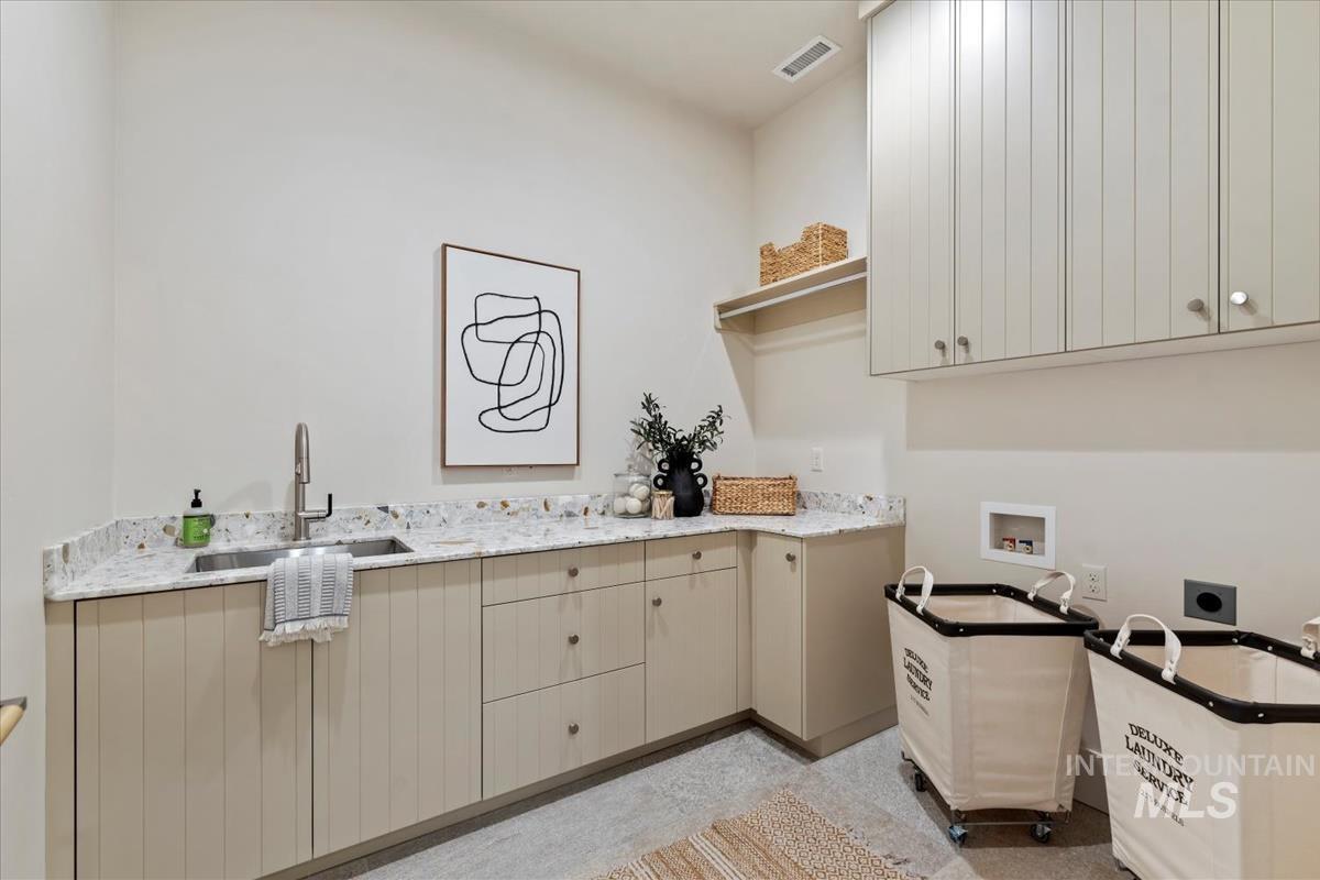 Washroom with cabinet space, washer hookup, and electric dryer hookup