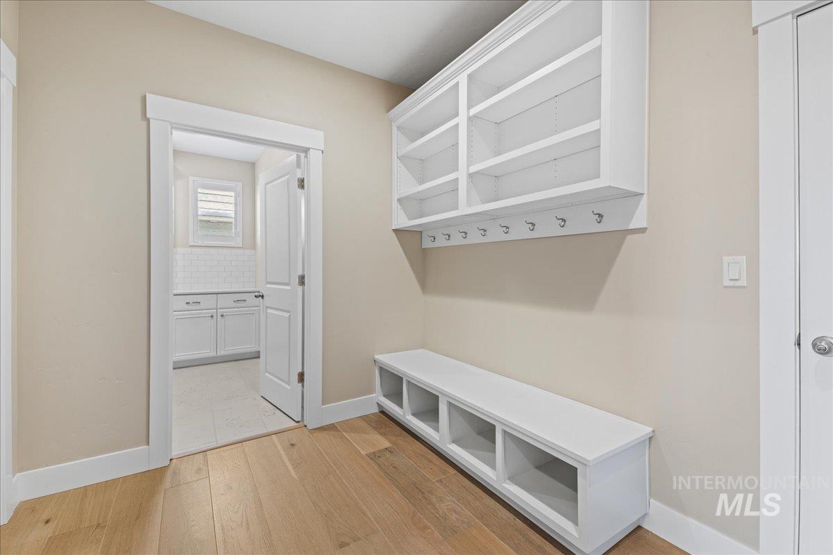 Mudroom featuring baseboards and light wood finished floors