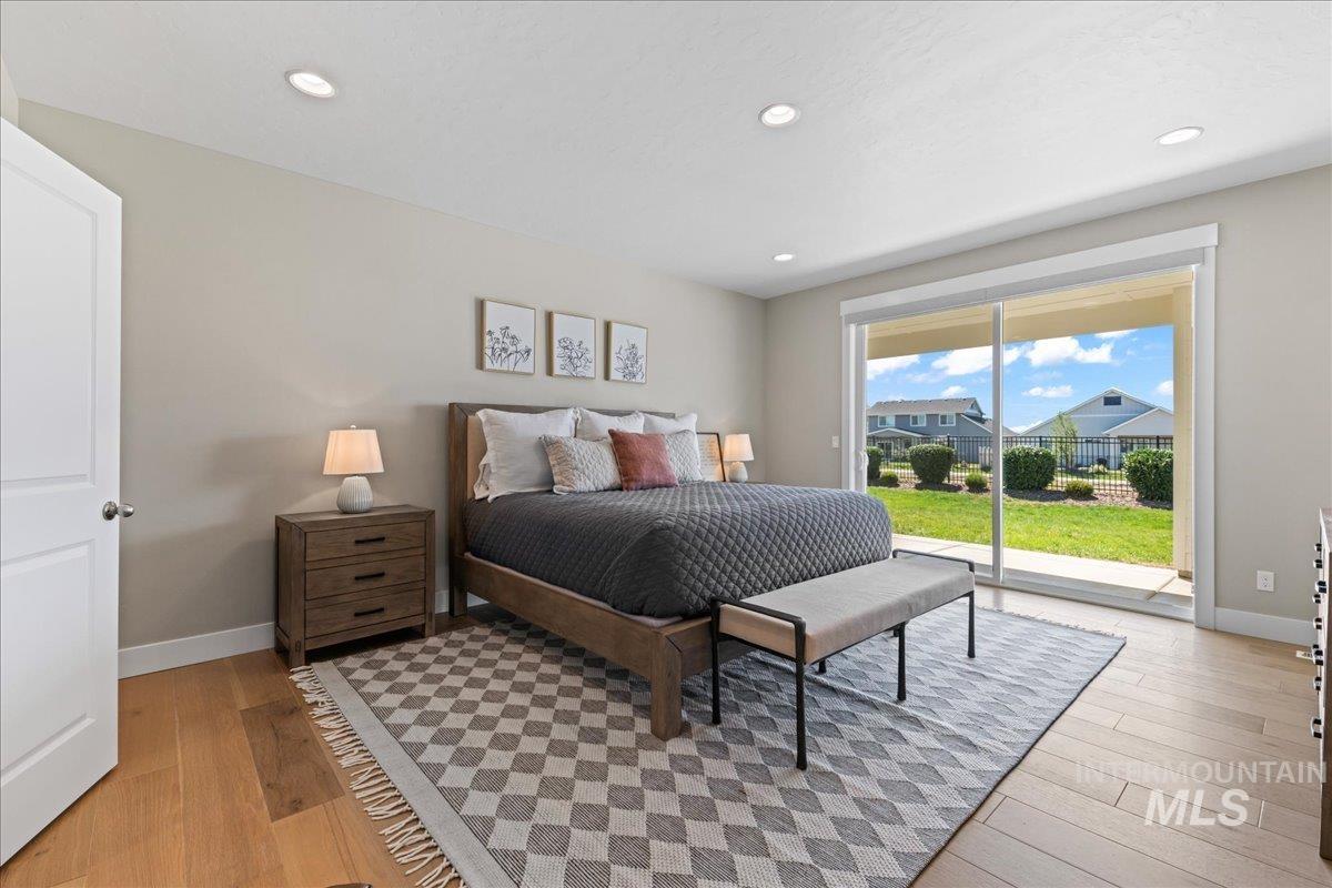 Bedroom featuring access to outside, light wood finished floors, and recessed lighting