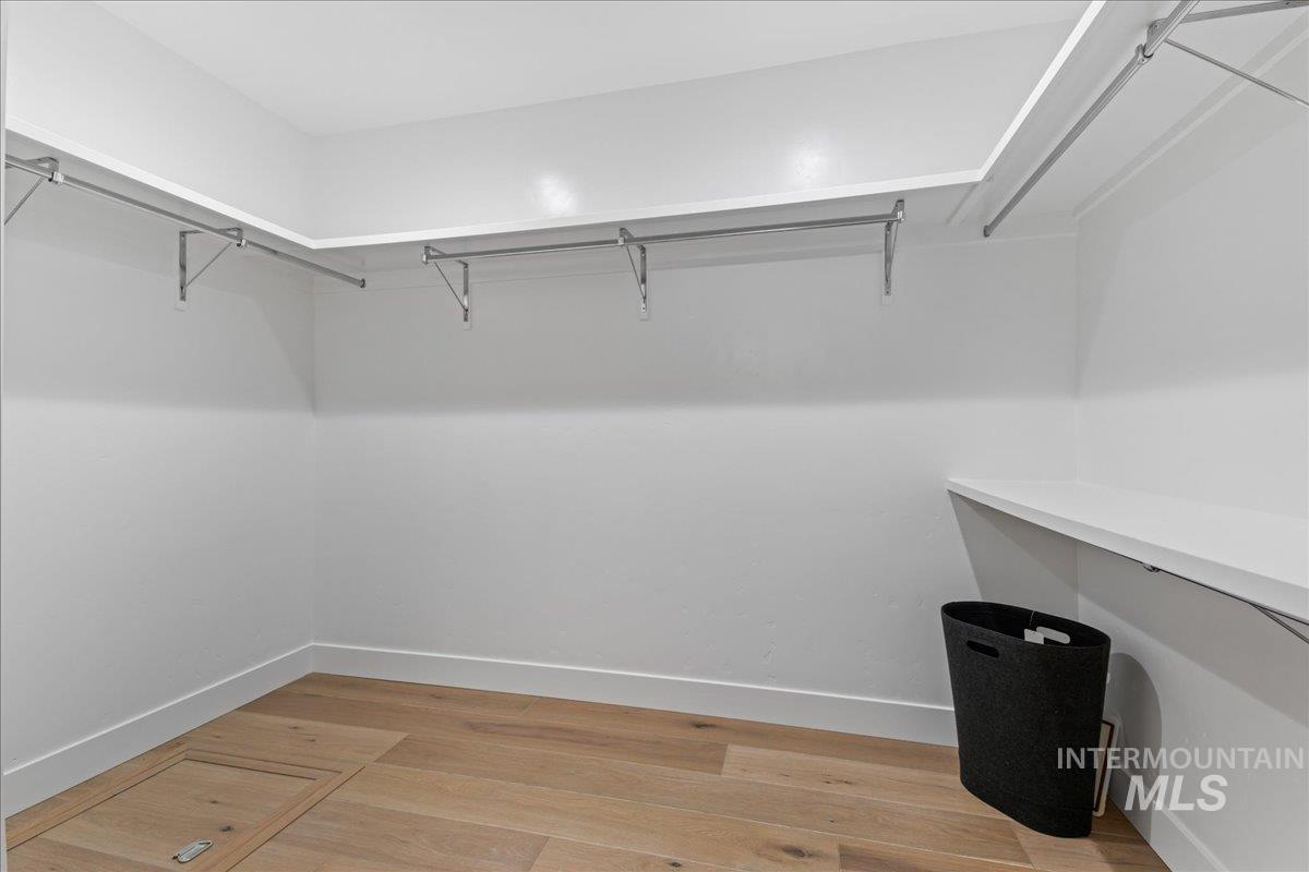 Walk in closet featuring light wood-type flooring