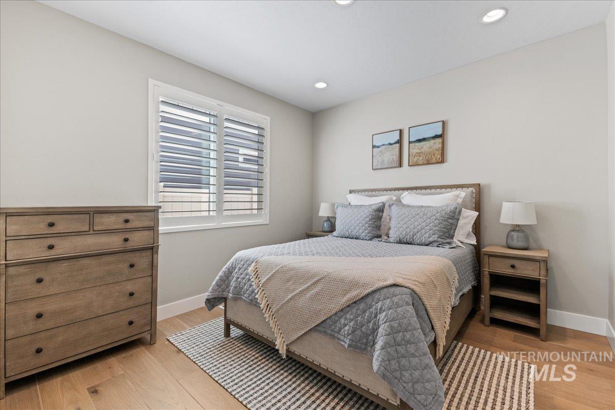 Bedroom with light wood finished floors and recessed lighting