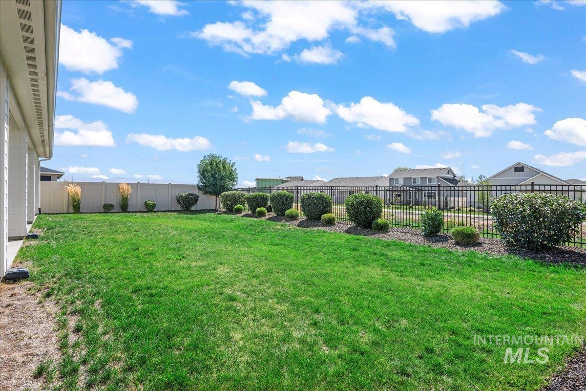 Fenced backyard with a residential view