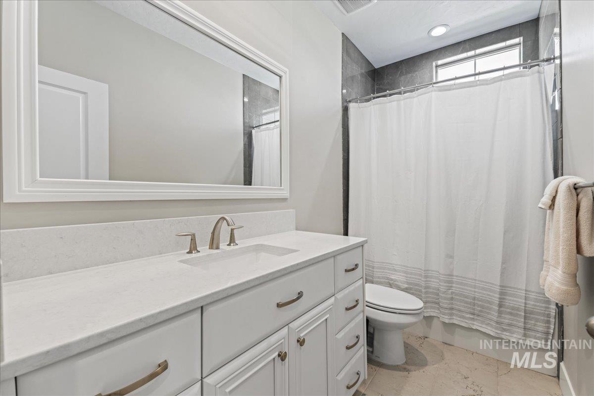Full bath with vanity and toilet
