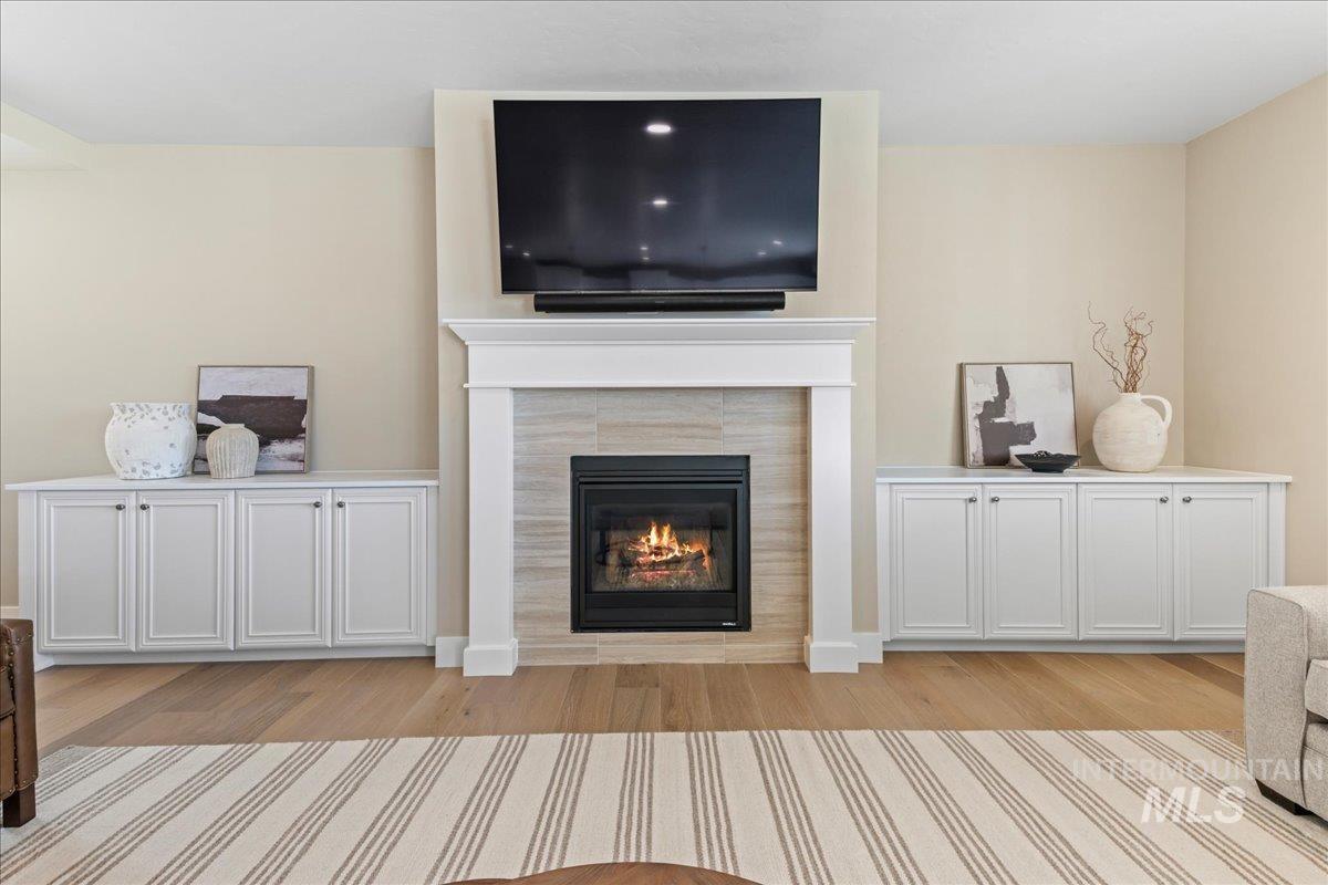 Living room featuring light wood-style floors and a fireplace