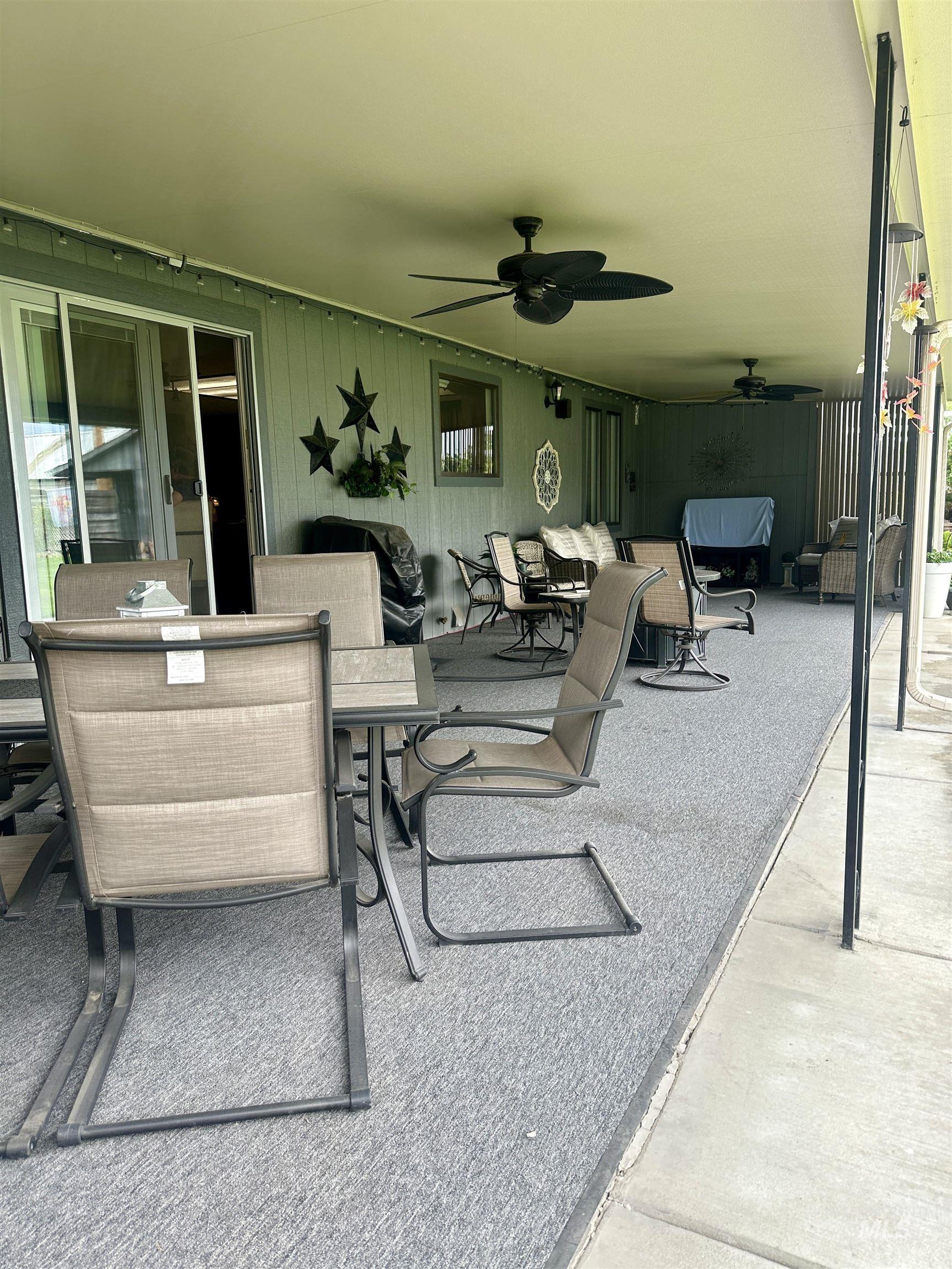 View of patio featuring a ceiling fan, outdoor lounge area, and outdoor dining space