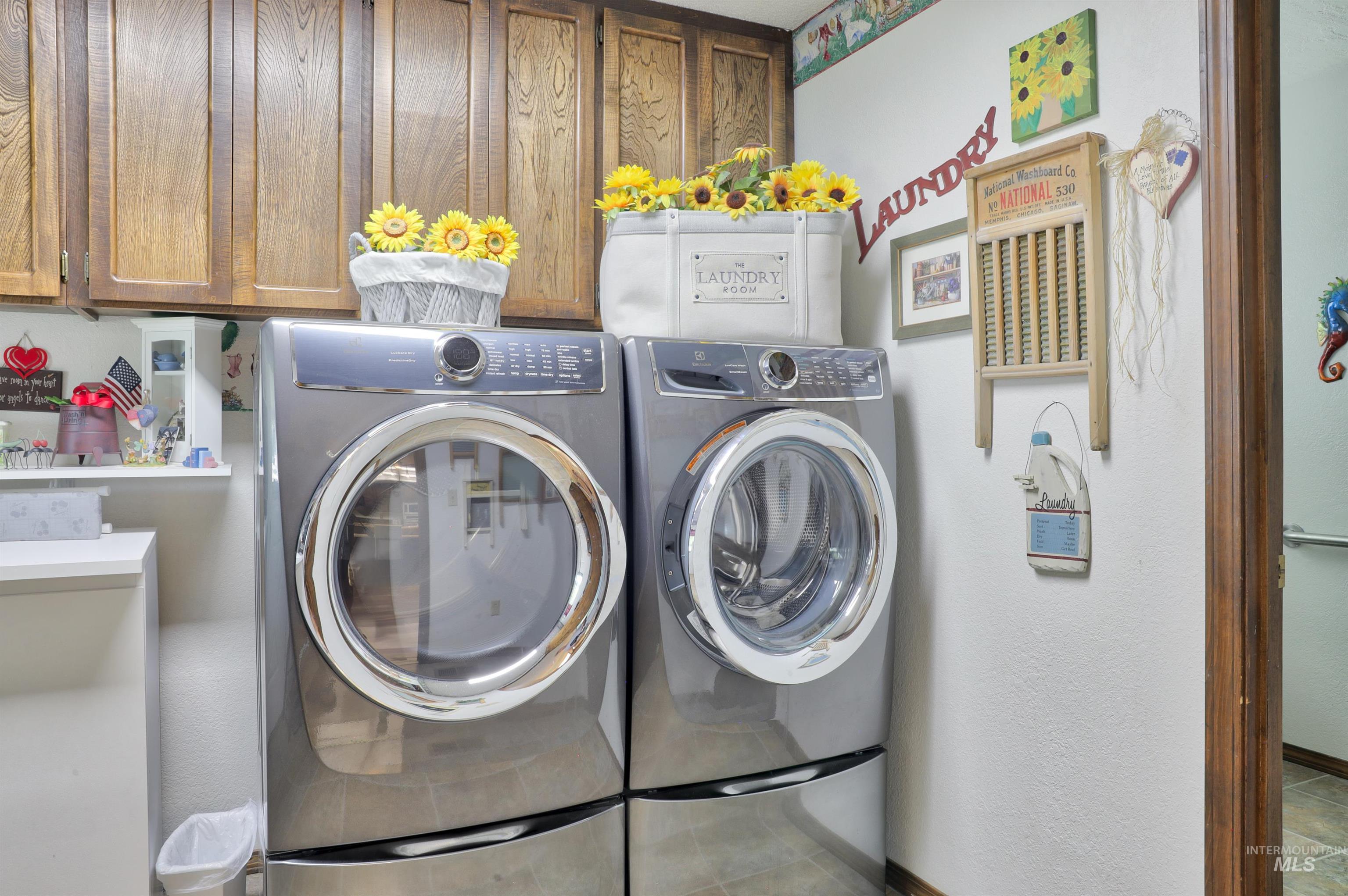 Laundry area featuring washer and dryer and cabinet space