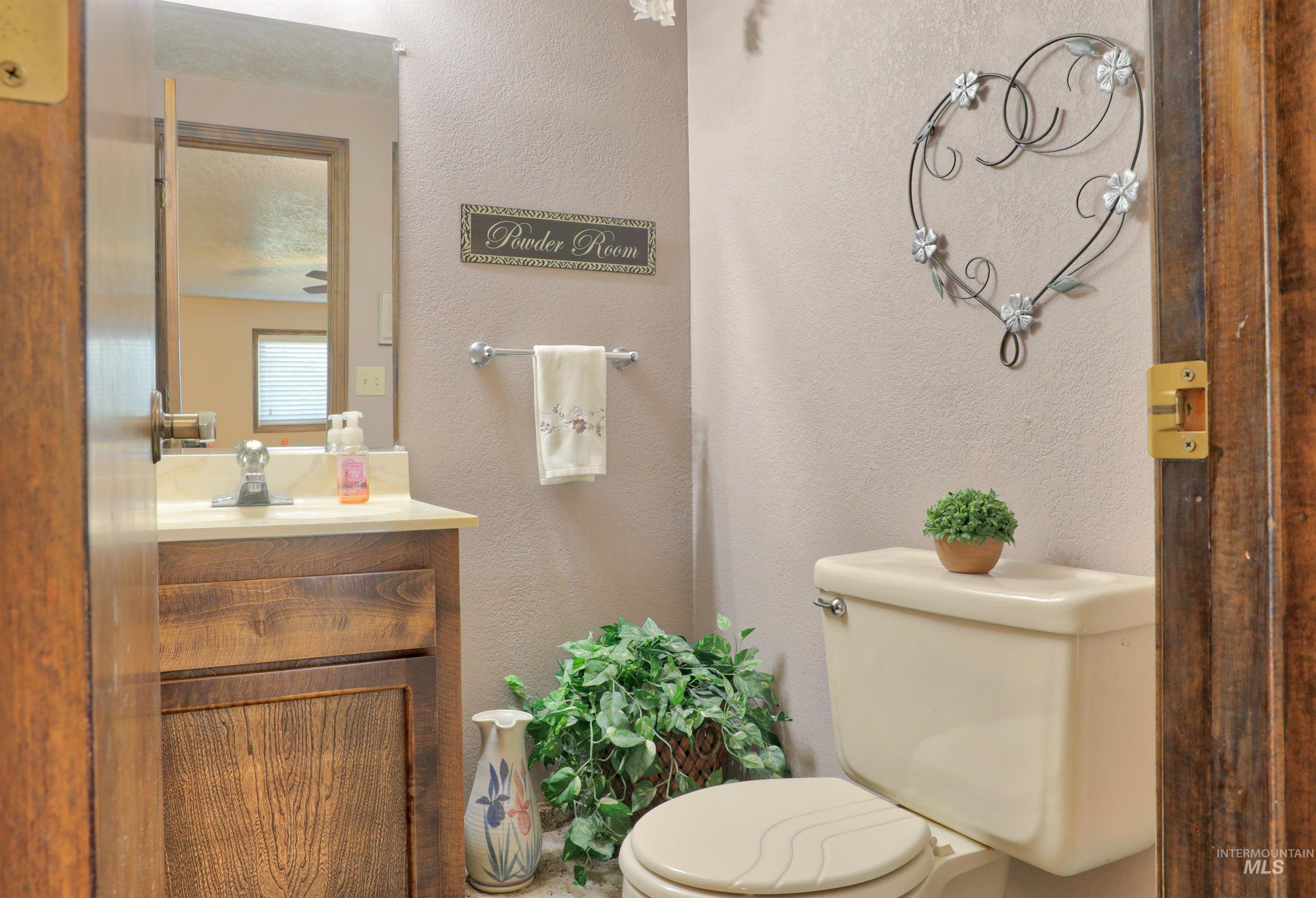Bathroom featuring a textured wall and vanity