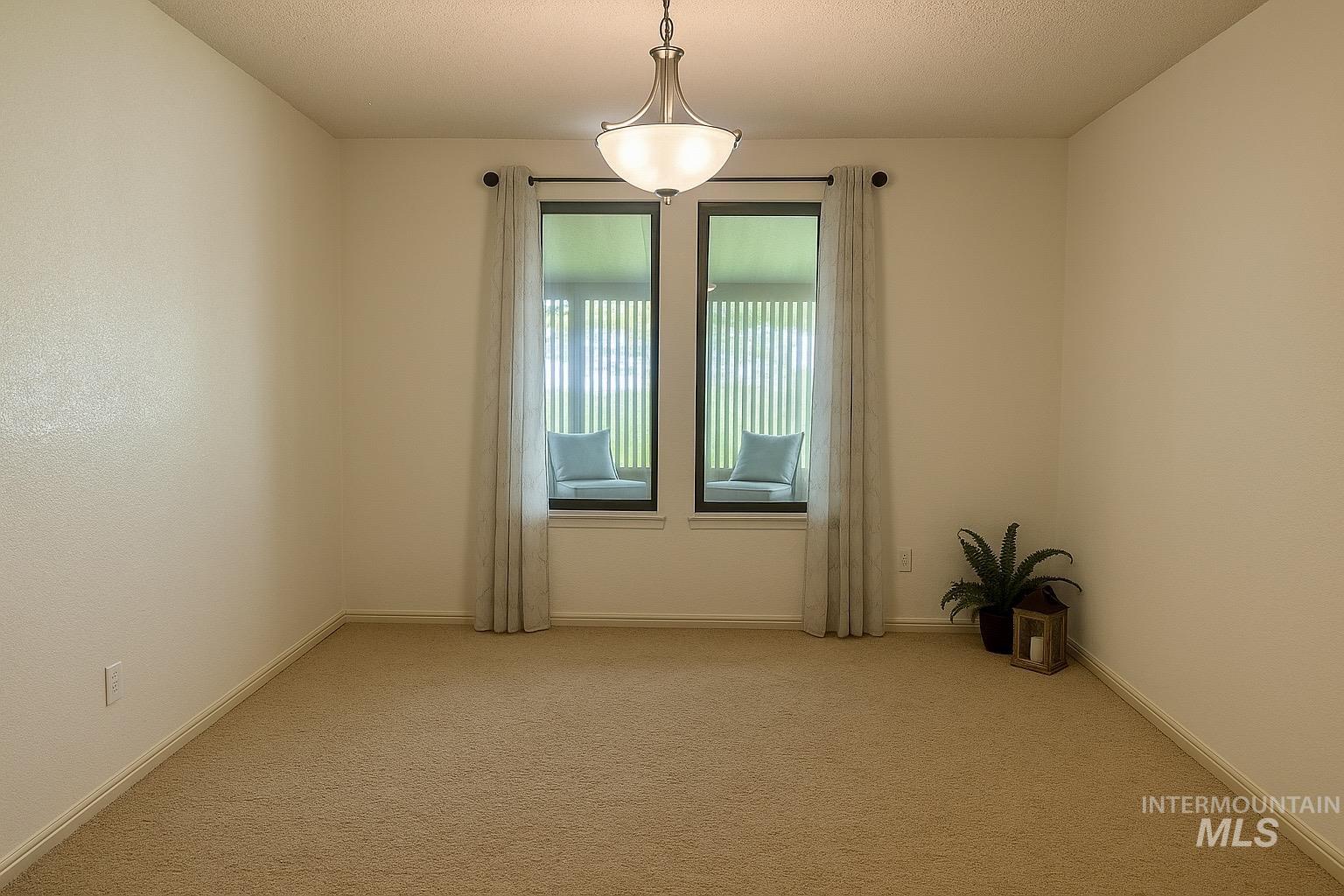 Carpeted empty room with baseboards and a textured ceiling