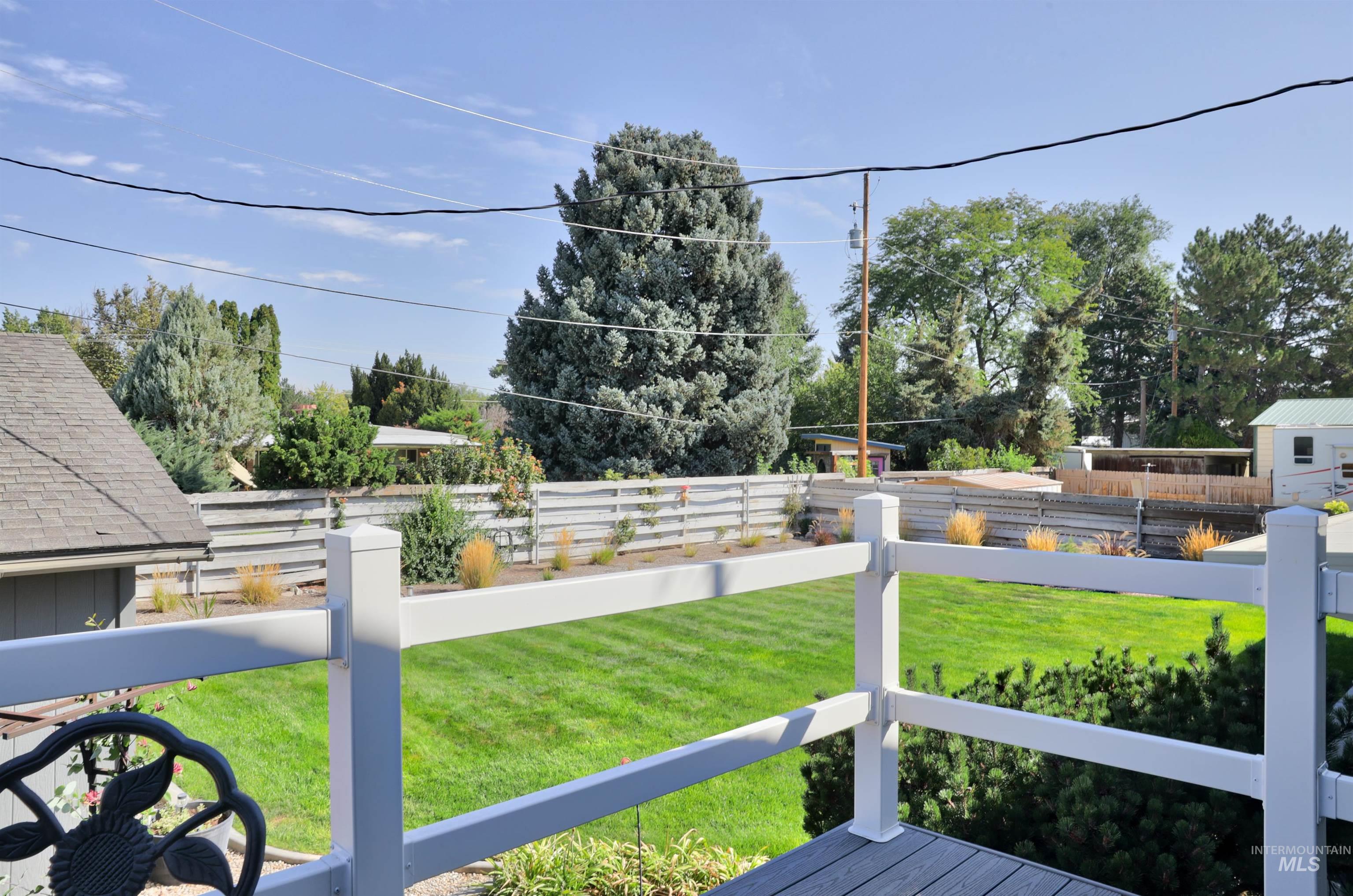 View of fenced backyard off of the master bedroom sitting deck