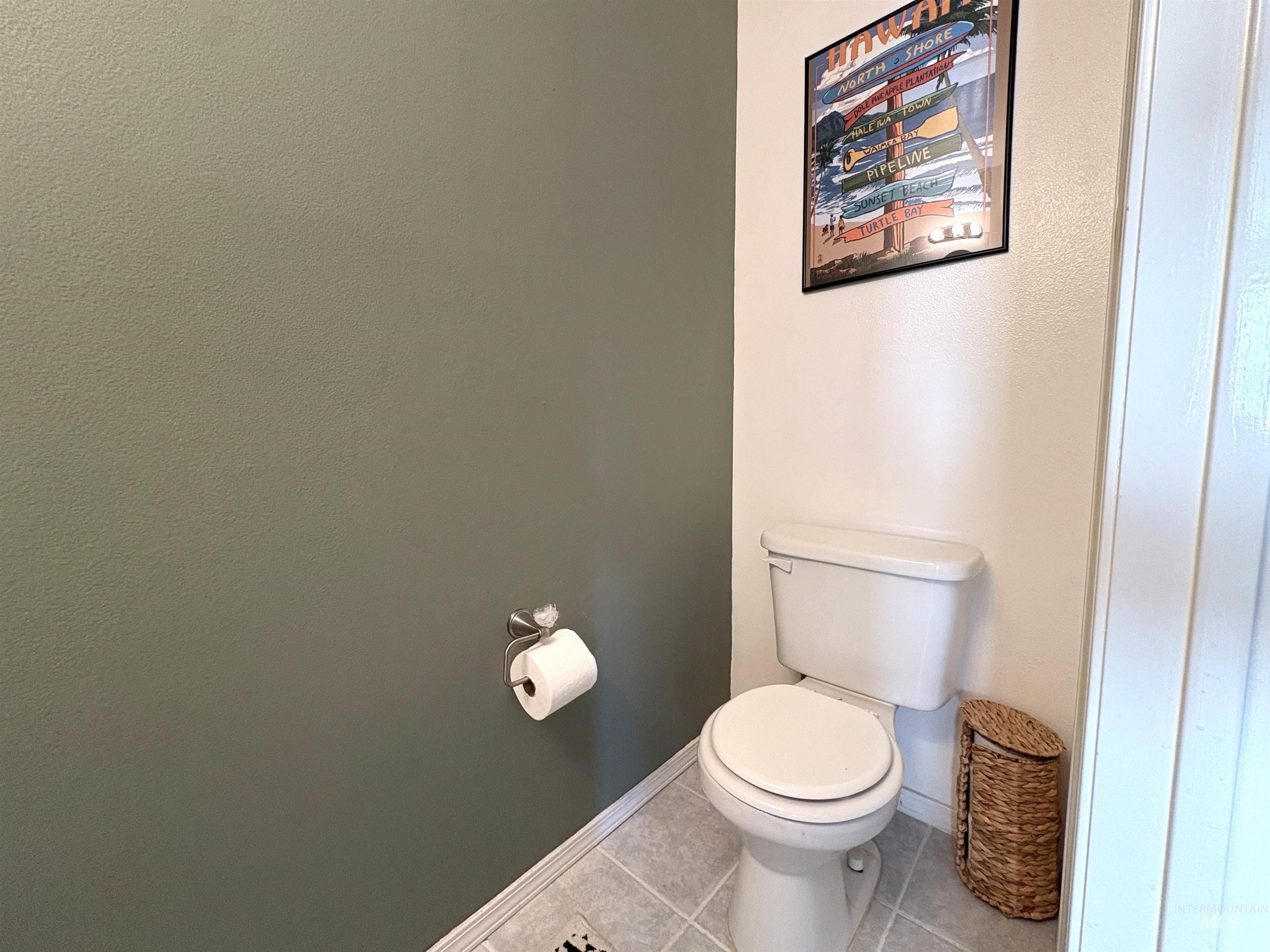 Bathroom with toilet and tile patterned floors