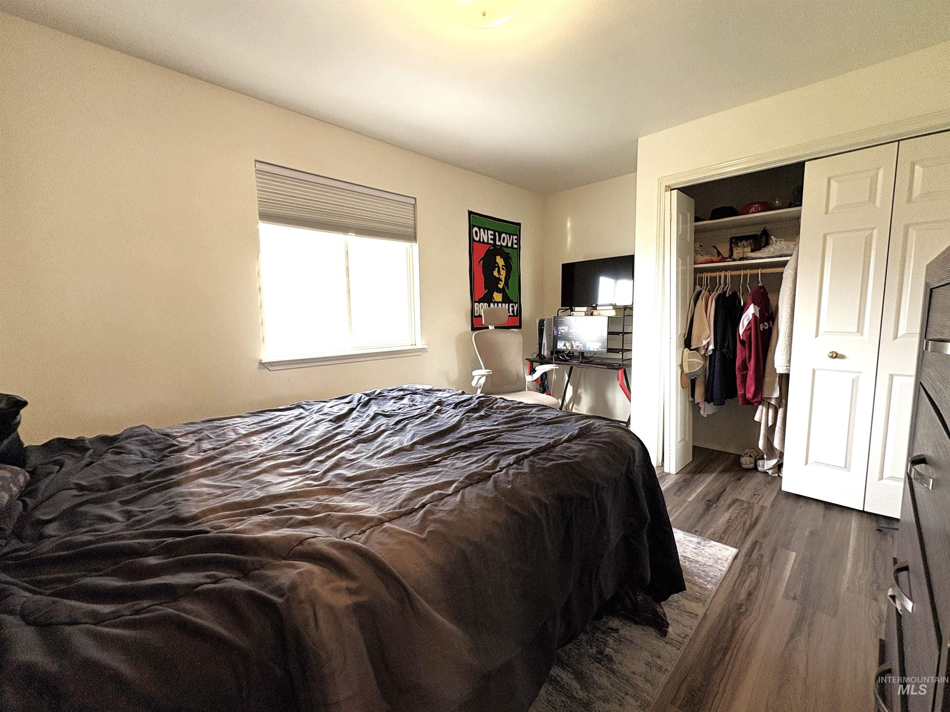Bedroom with dark wood-type flooring