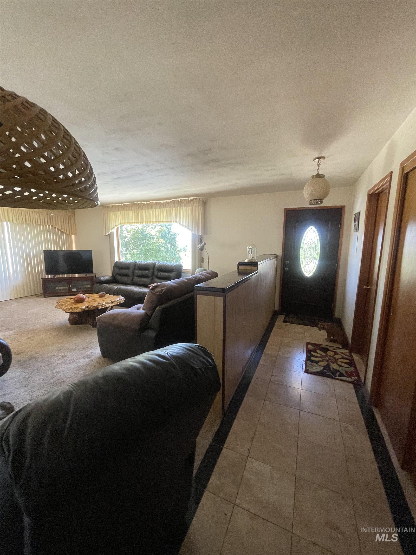 Living area featuring light tile patterned floors