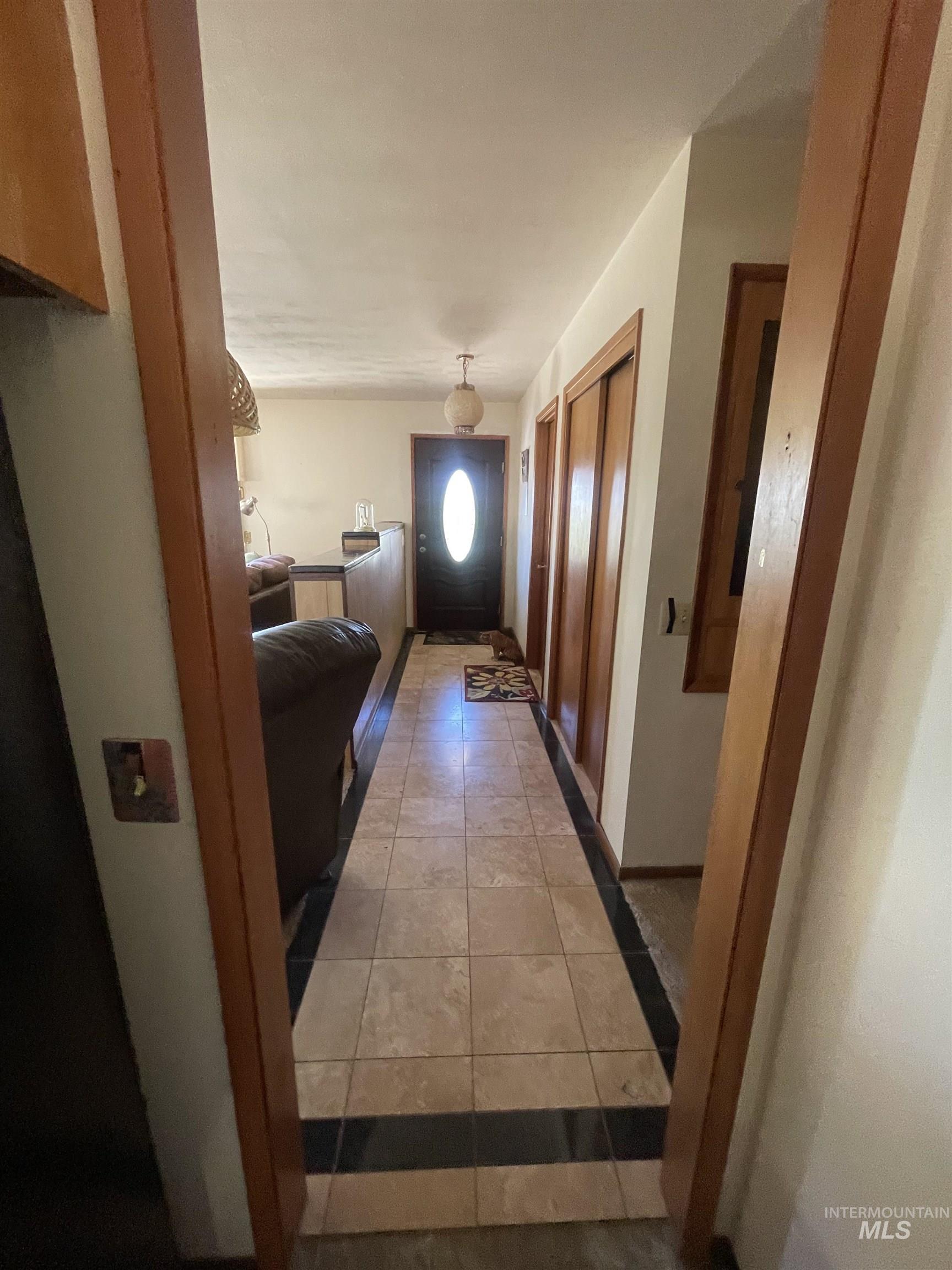 Corridor featuring light tile patterned floors