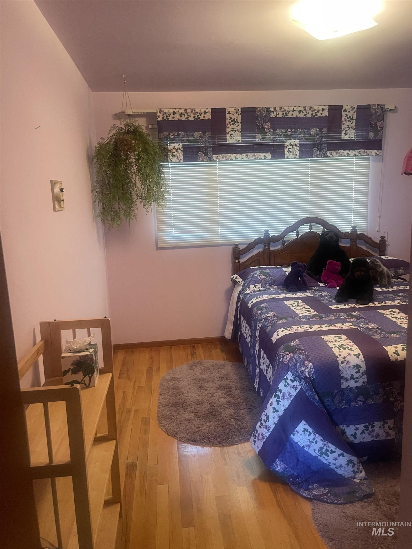 Bedroom with light wood-style flooring and baseboards