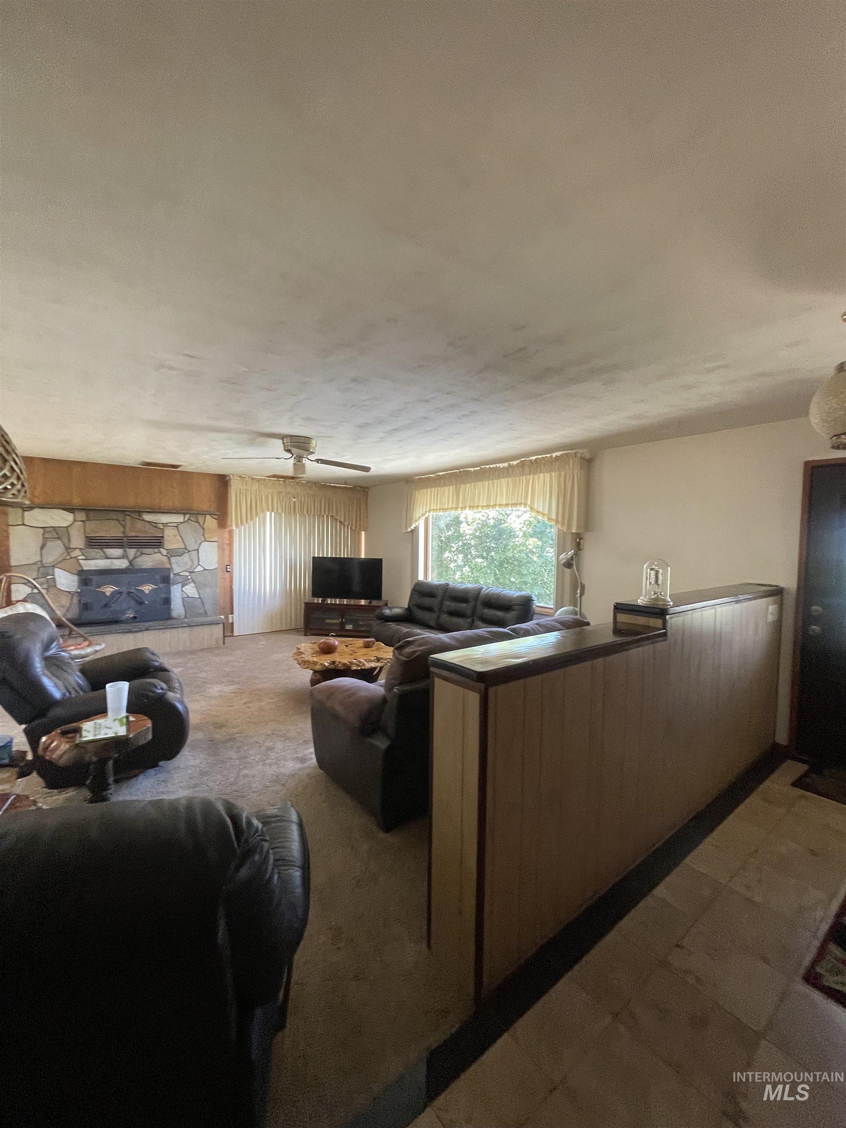 Living area featuring dark carpet and wooden walls
