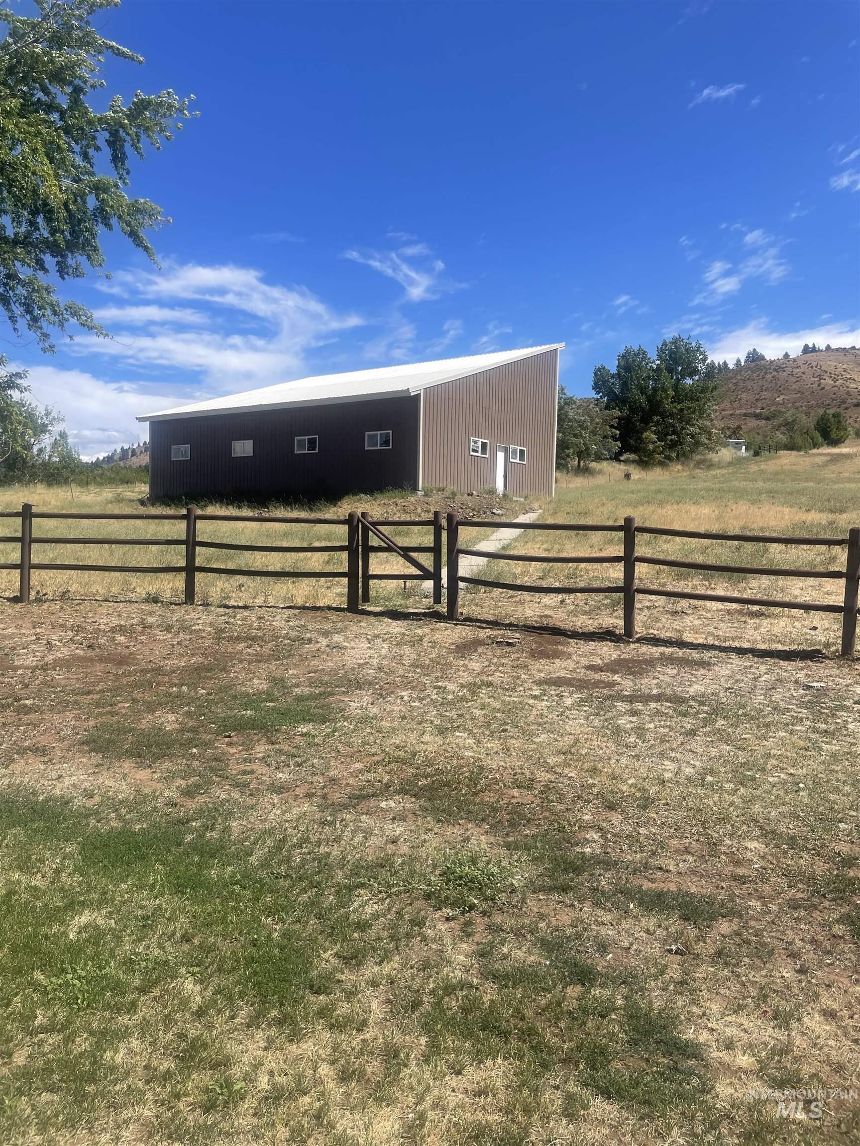 View of yard featuring an outbuilding, a rural view, and a pole building