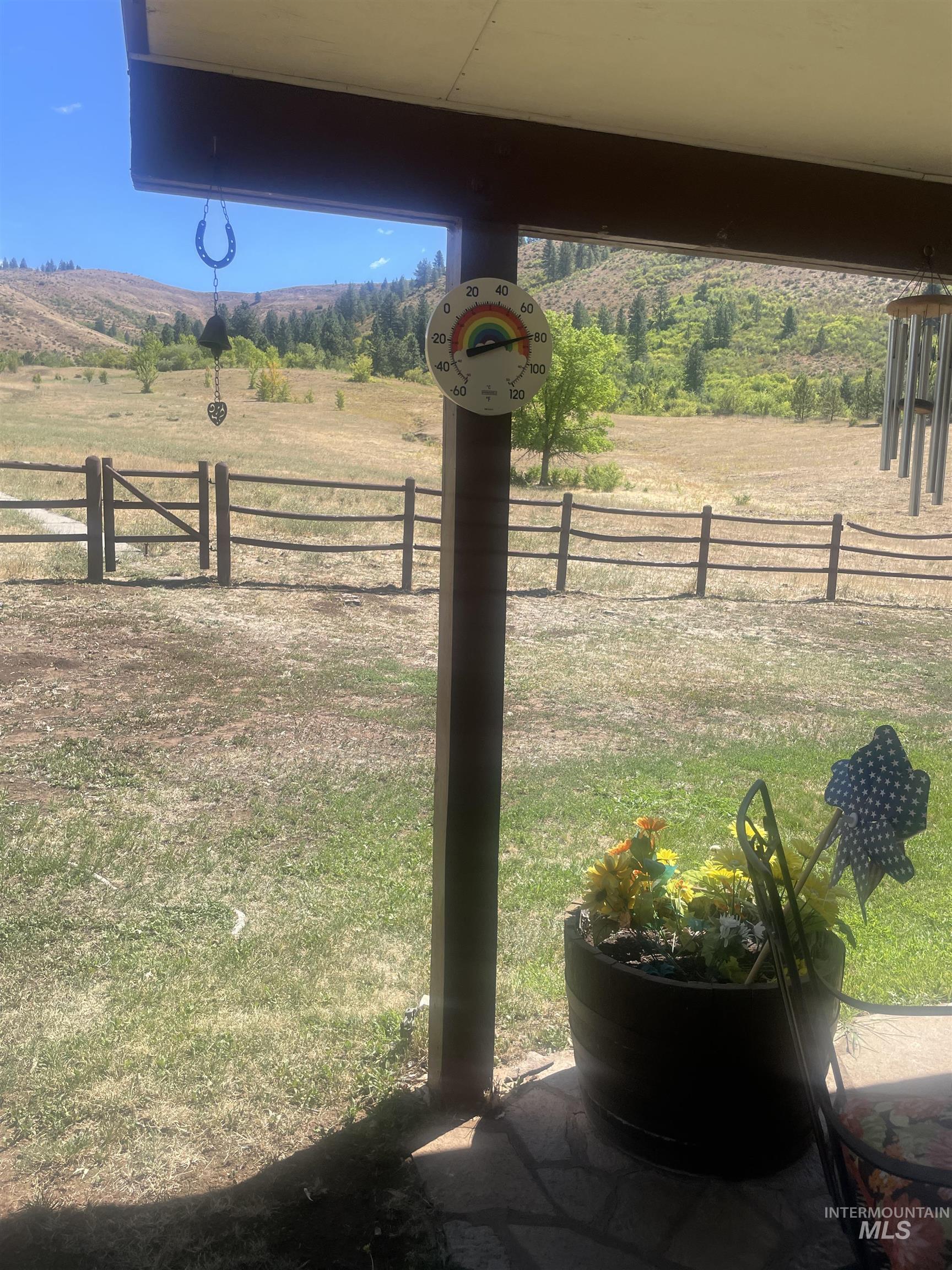 View of yard with a rural view and a mountain view
