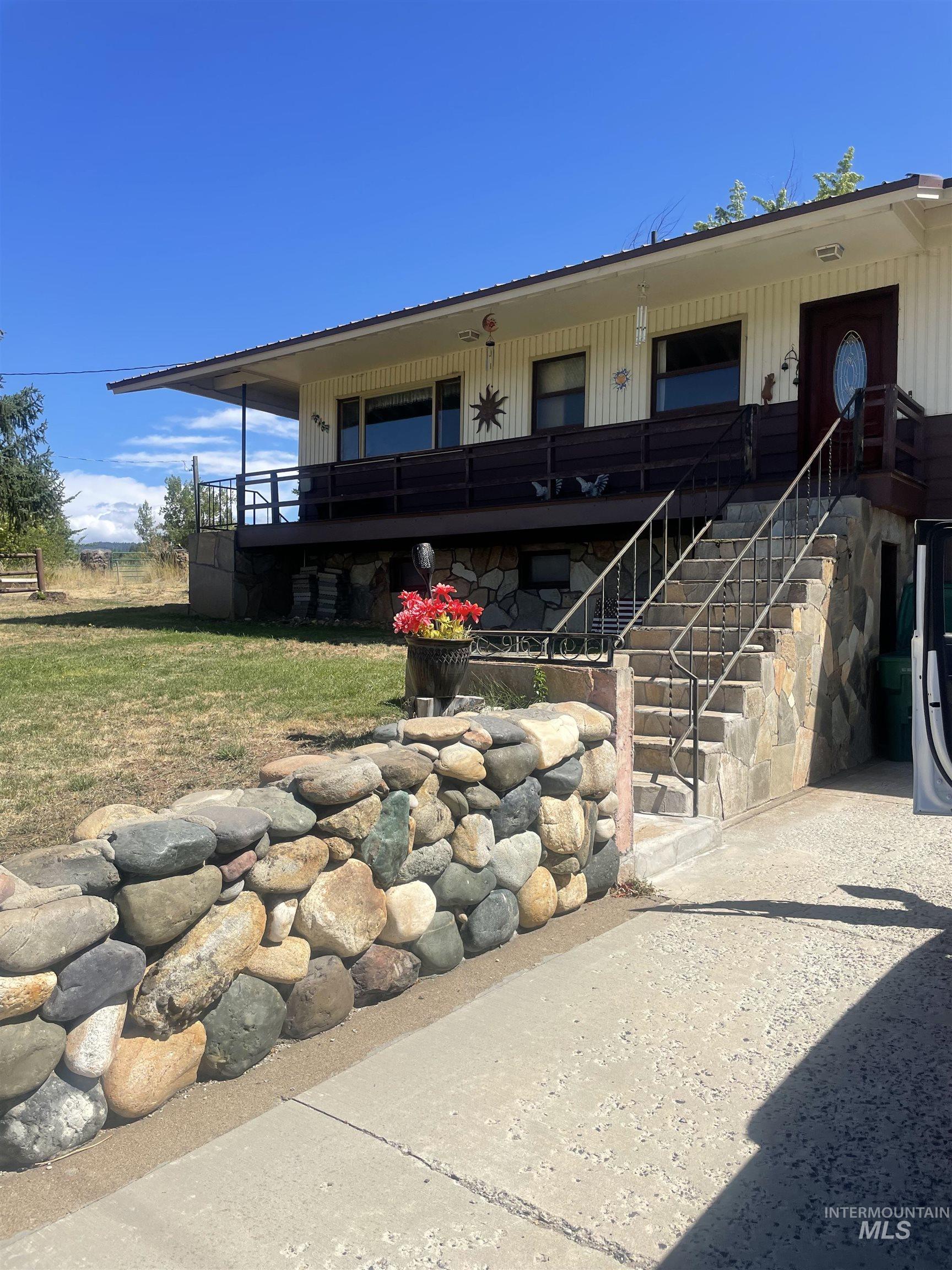 Rear view of house with stairway and covered porch