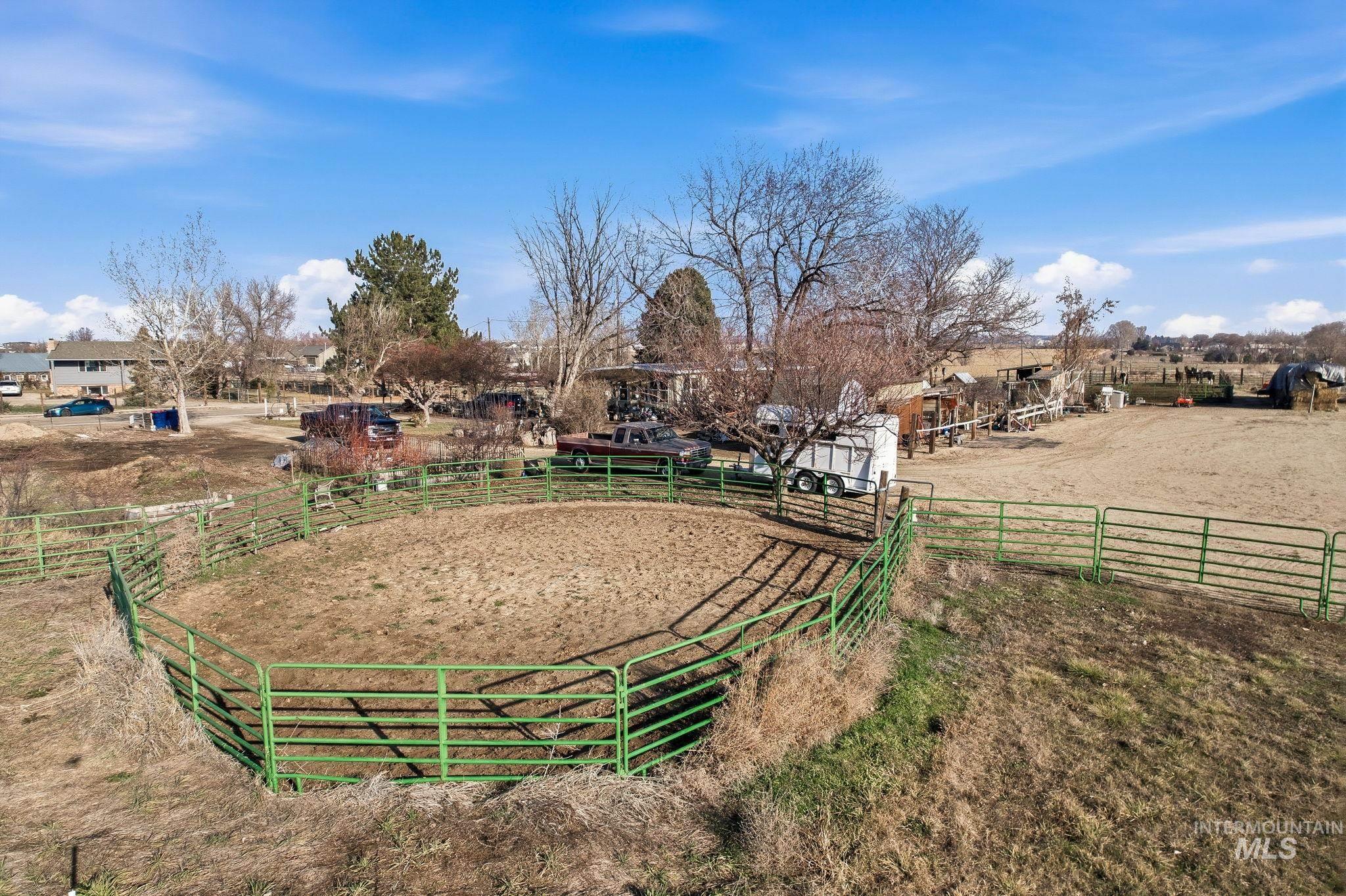 View of yard with an enclosed riding area and a rural view