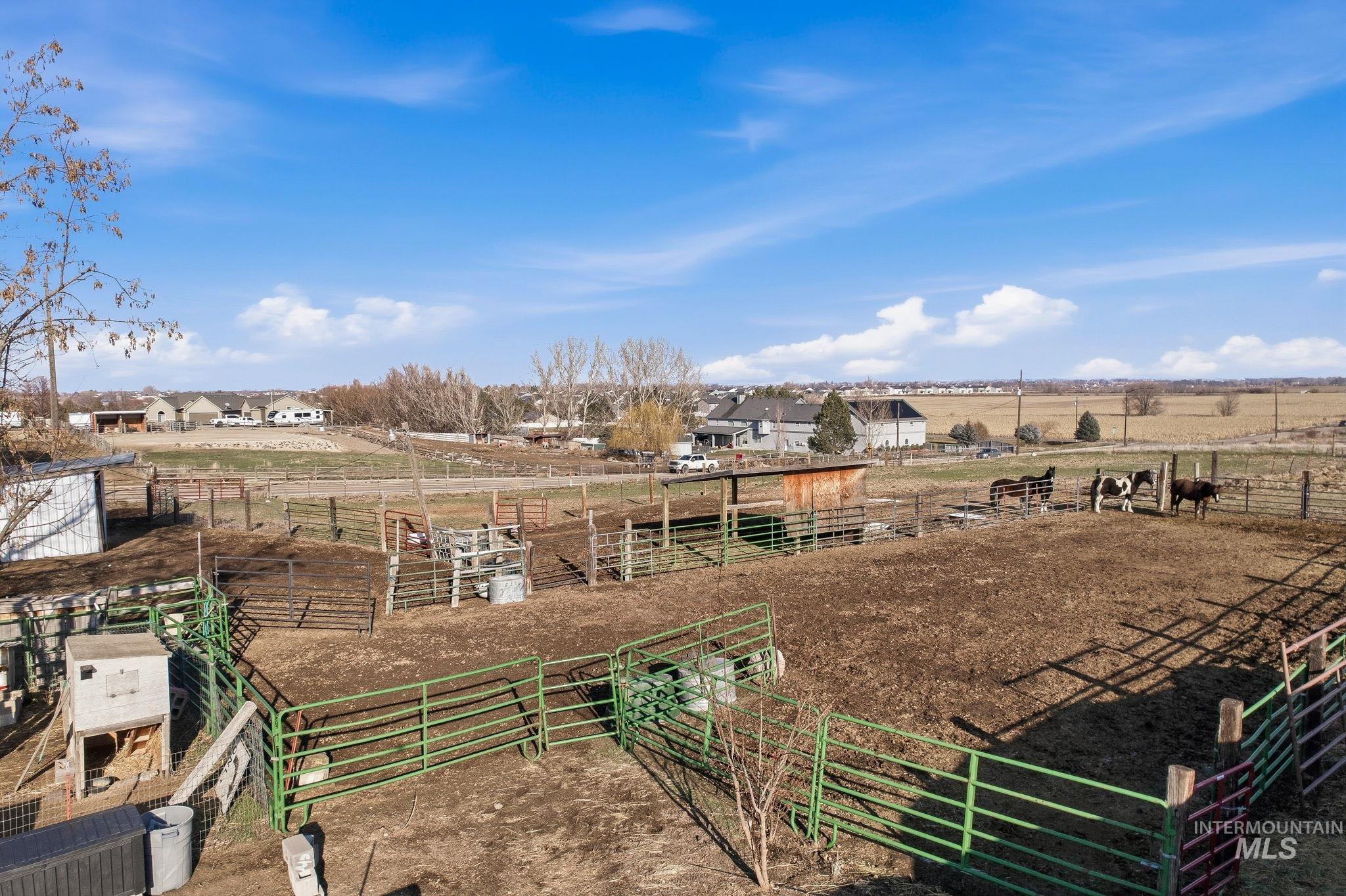 View of yard with a view of rural / pastoral area, an exterior structure, and an outbuilding