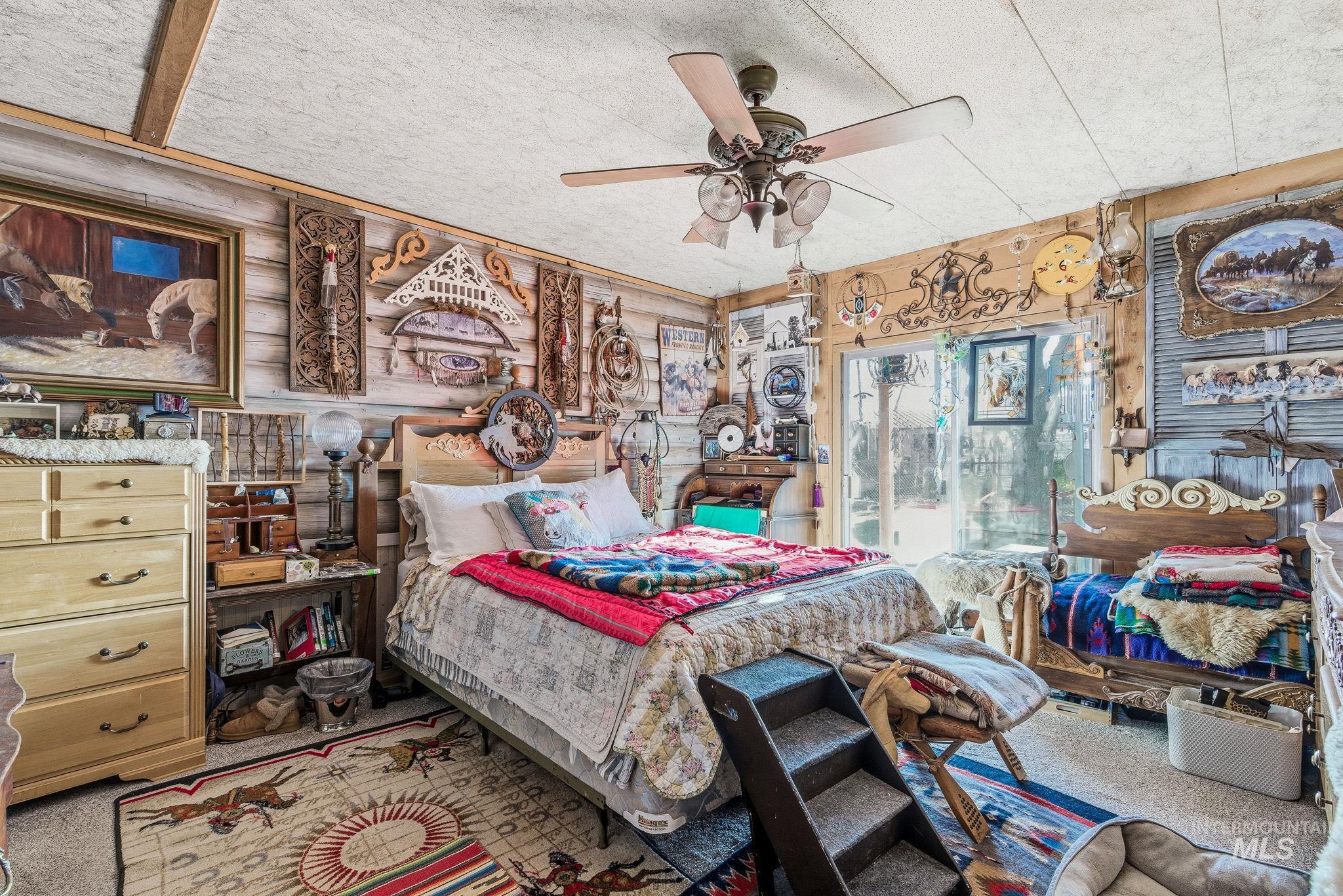 Carpeted bedroom with a ceiling fan