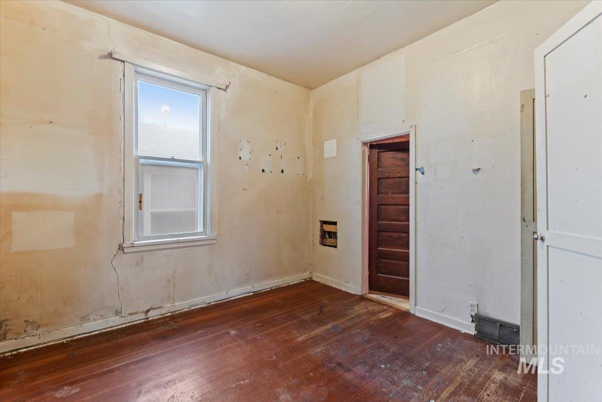 Wood floors with access to bathroom.