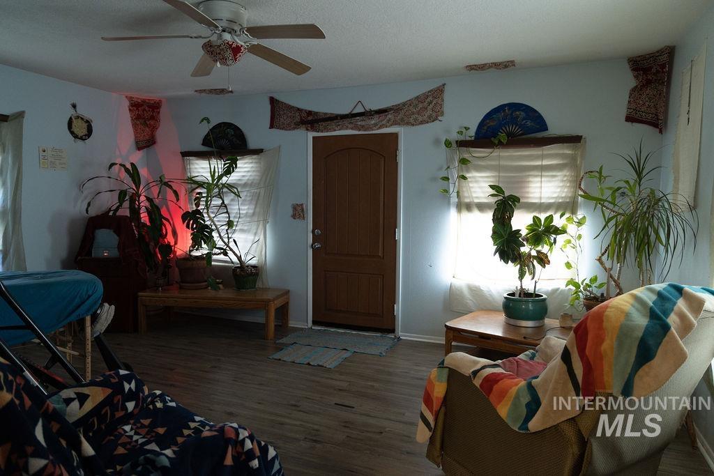 Living area featuring wood finished floors and ceiling fan