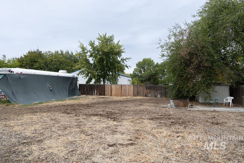View of yard with a storage unit