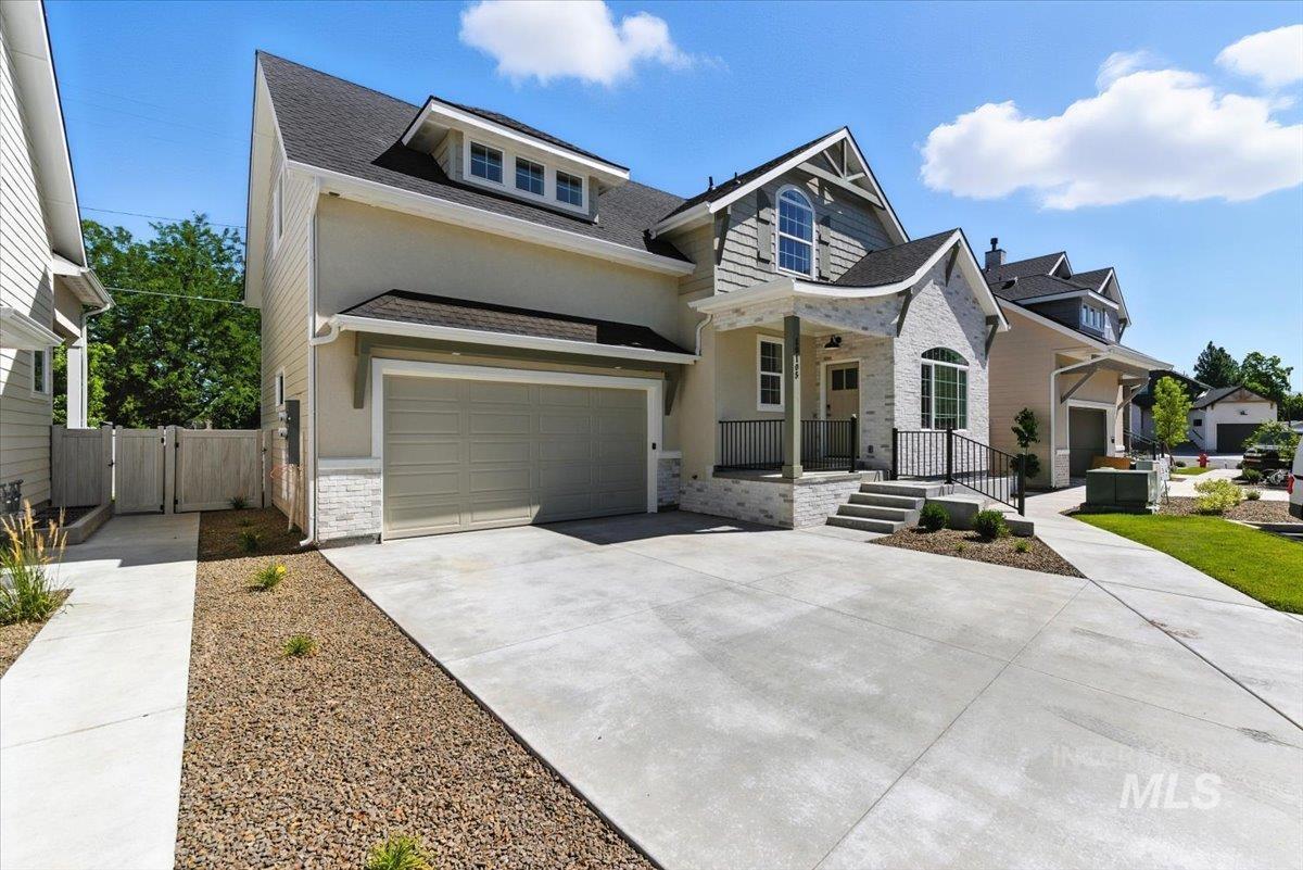 View of front of property with a garage, concrete driveway, a gate, a shingled roof, and covered porch