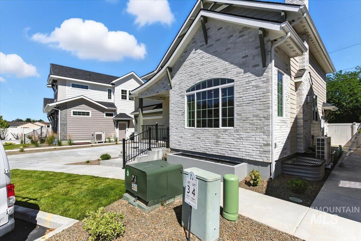View of side of home with a central air condition unit
