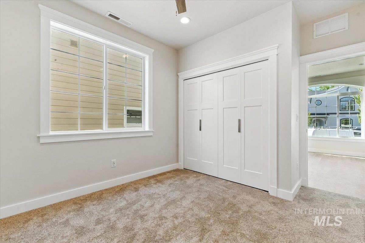 Unfurnished bedroom featuring carpet flooring, a closet, recessed lighting, and a ceiling fan