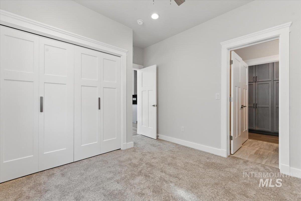 Unfurnished bedroom featuring carpet flooring and a closet