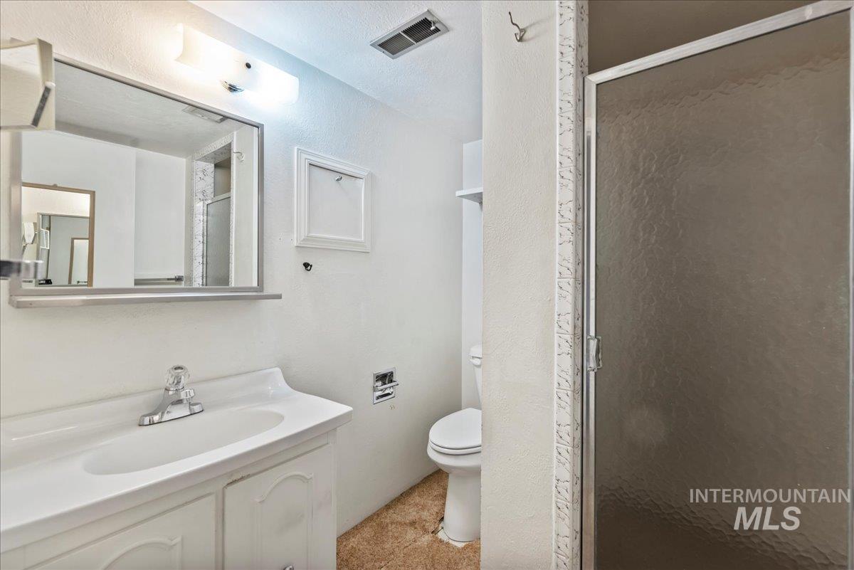 Bathroom with vanity and a stall shower