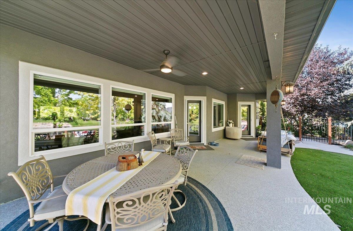 View of patio with a ceiling fan and outdoor dining space