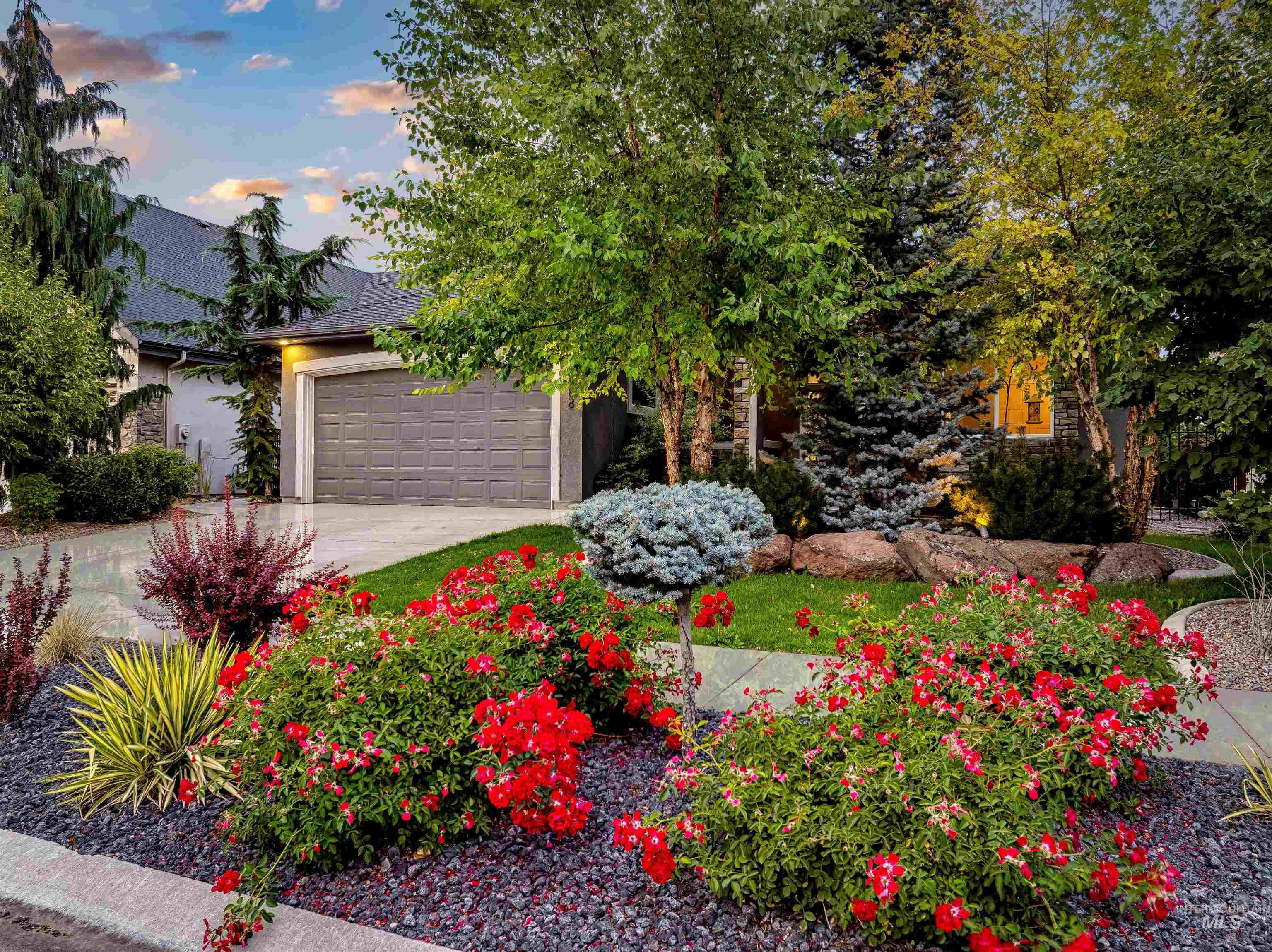 Obstructed view of property featuring concrete driveway, a garage, roof with shingles, and stucco siding
