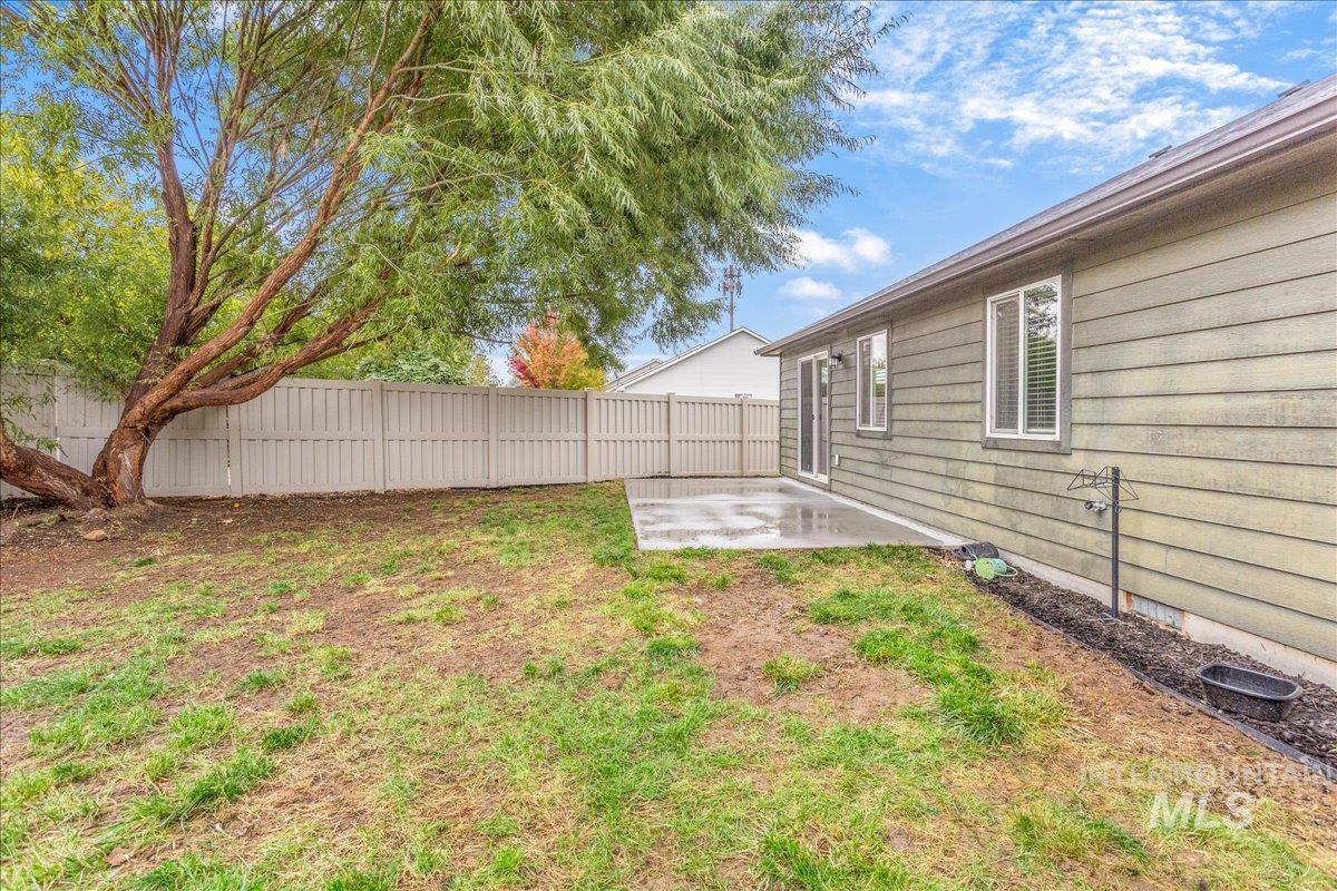 Fenced backyard featuring a patio