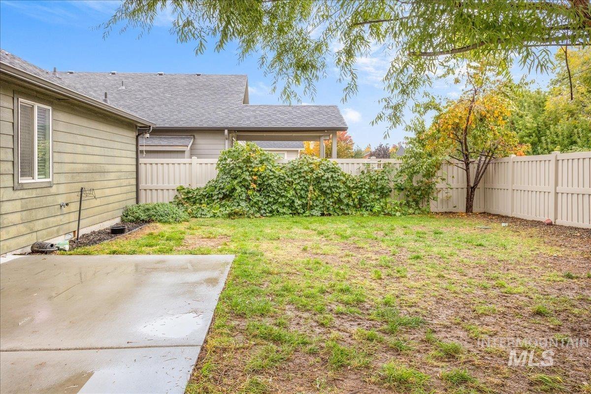 Fenced backyard with a patio area