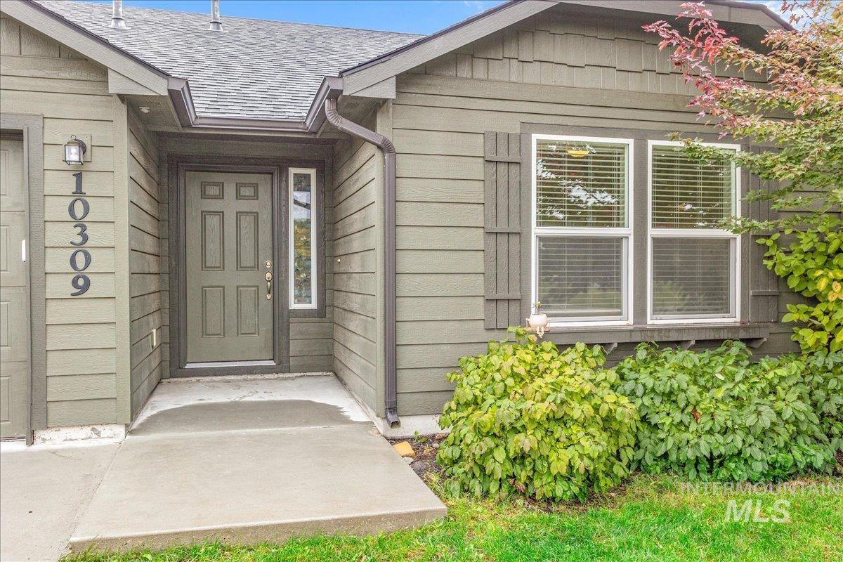 Property entrance with a shingled roof