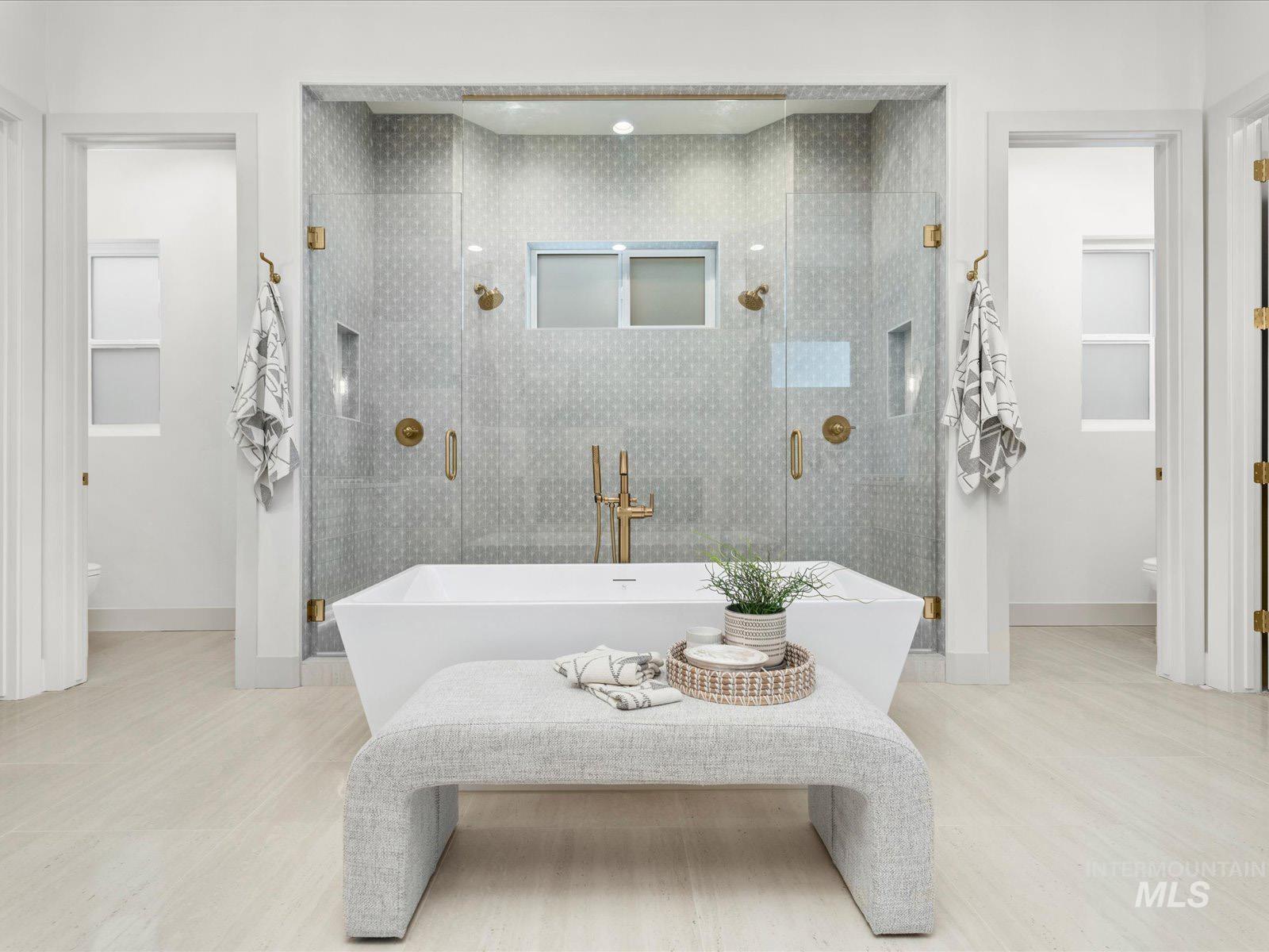Full bathroom featuring a stall shower, a freestanding tub, and light wood-style flooring