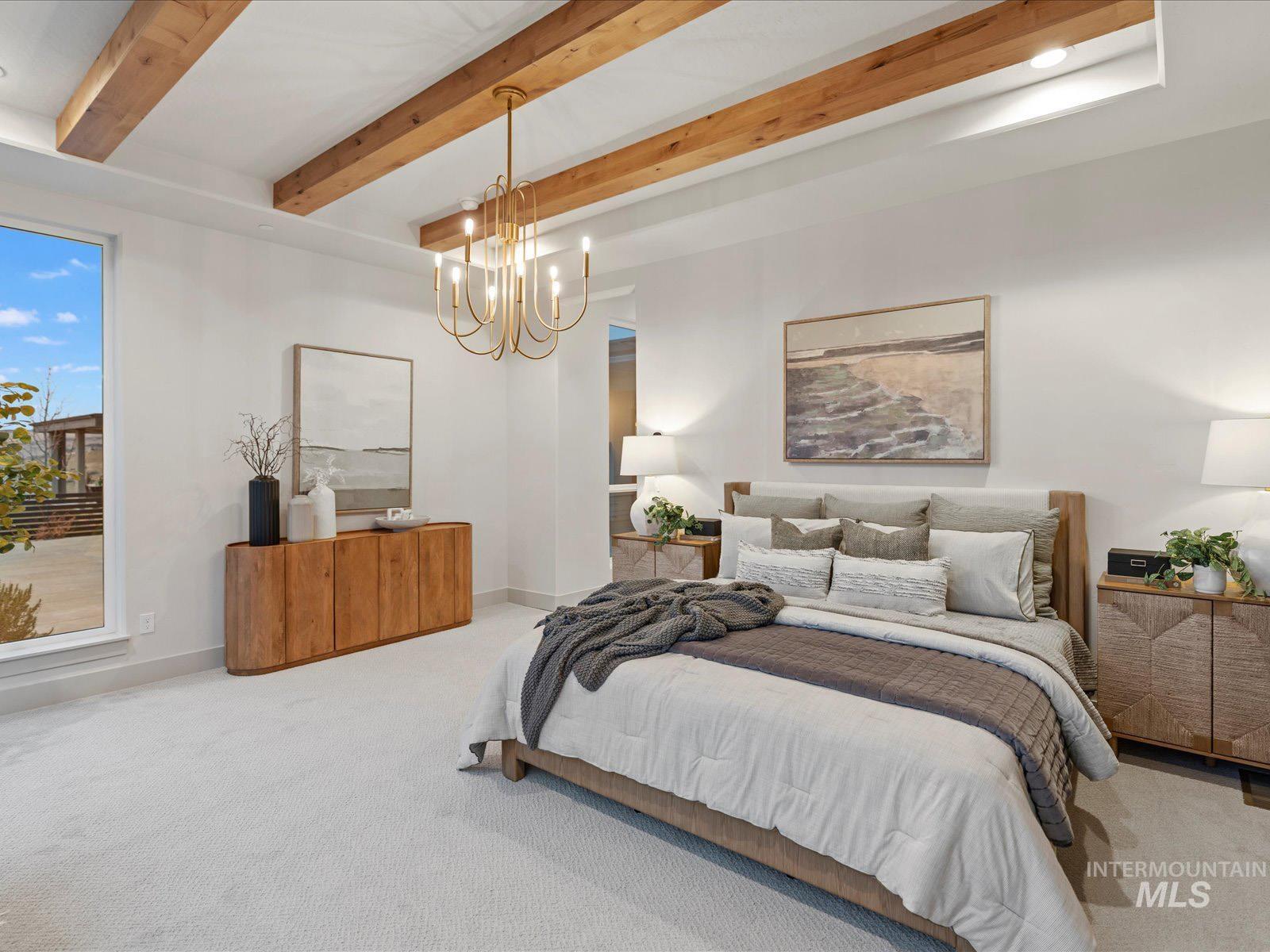 Carpeted bedroom with beam ceiling and a chandelier