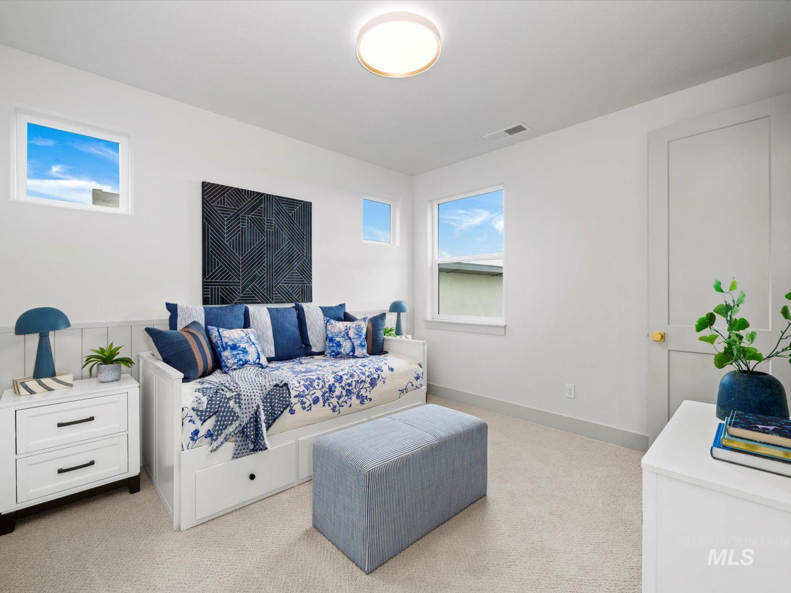 Bedroom with light carpet and baseboards