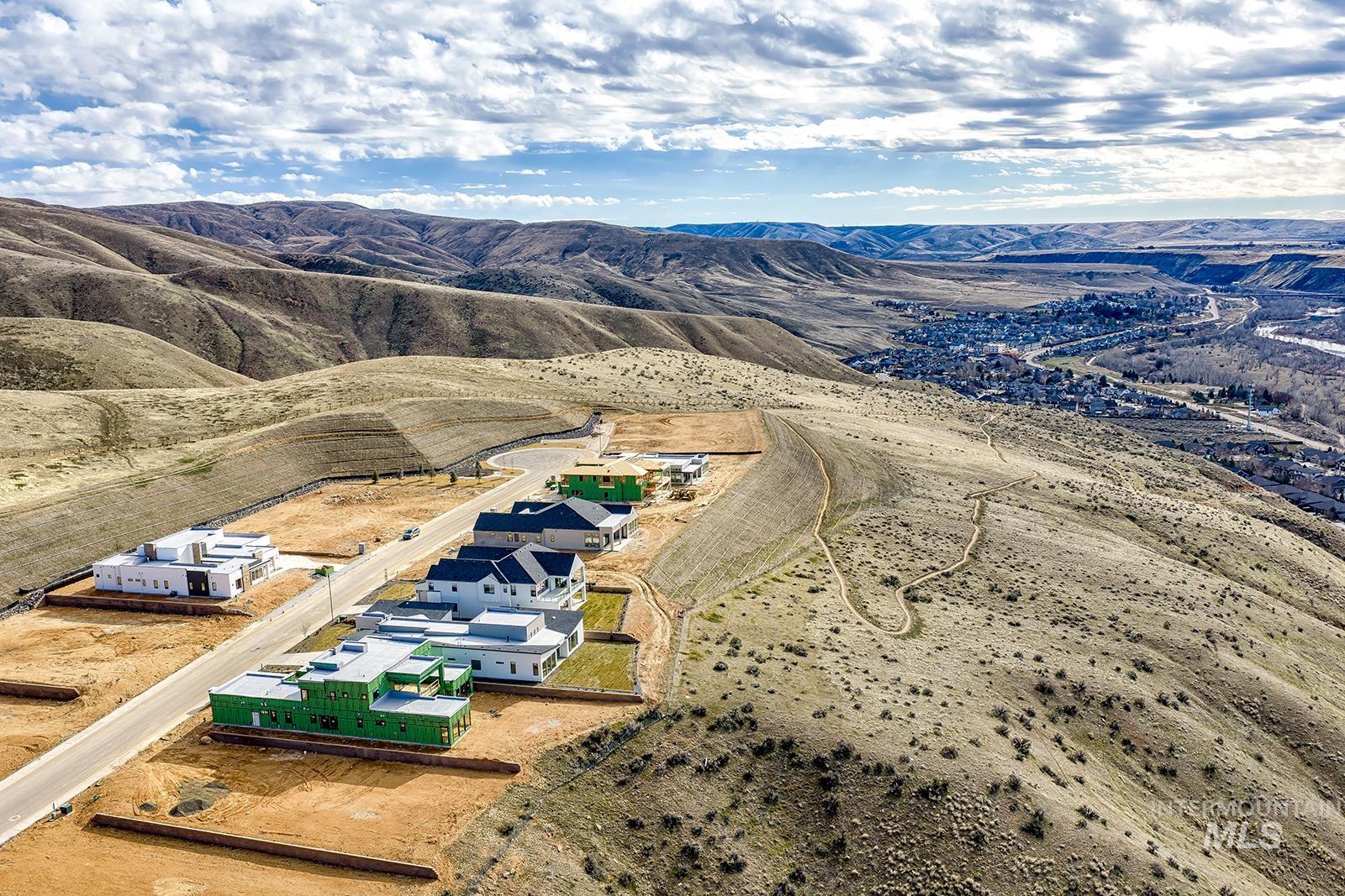 Aerial view of property and surrounding area featuring rural landscape and mountains
