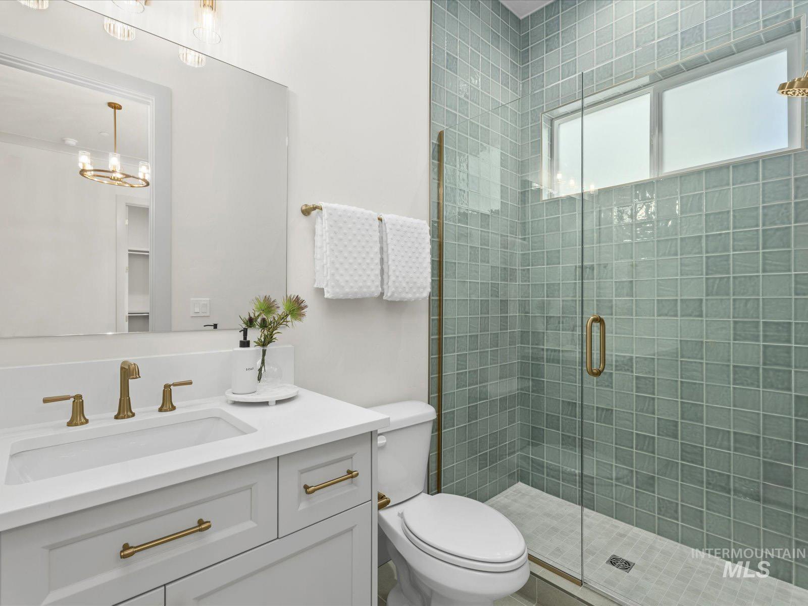 Bathroom featuring vanity and a stall shower